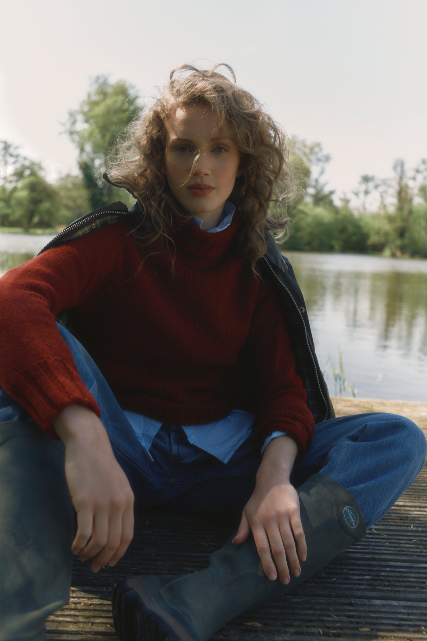 Model wearing a Big Softy Geelong Chunky Polo Neck Womens Jumper in colour Russet Red.