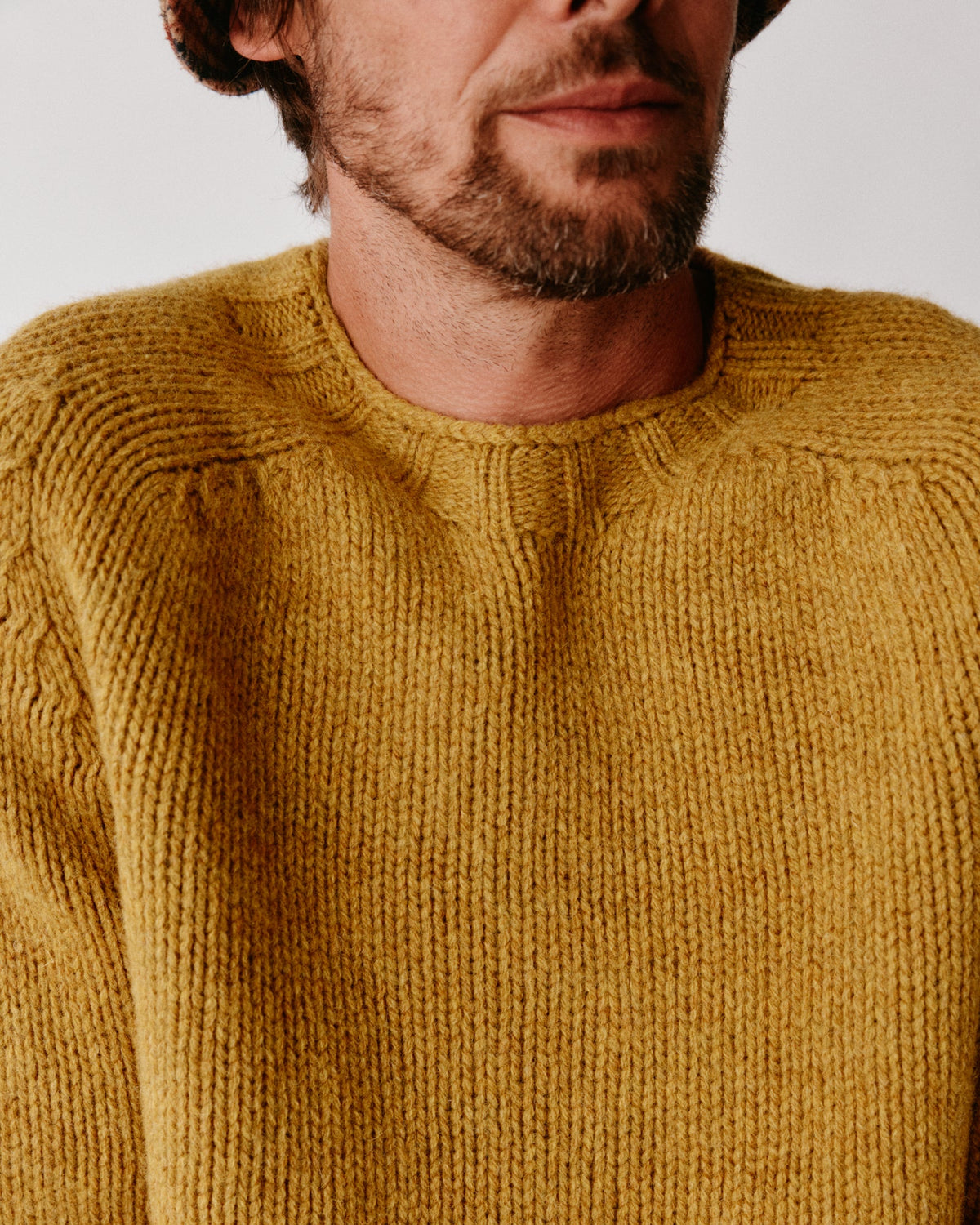 Model wearing the Bosie Blue Mogganer Explorer Extra Chunky Seamless Supersoft Shetland Sweater in Gold Dust / Cummin – seamless, seam-free pure wool, knitted in Scotland by Harley of Scotland for Bosie Knitwear