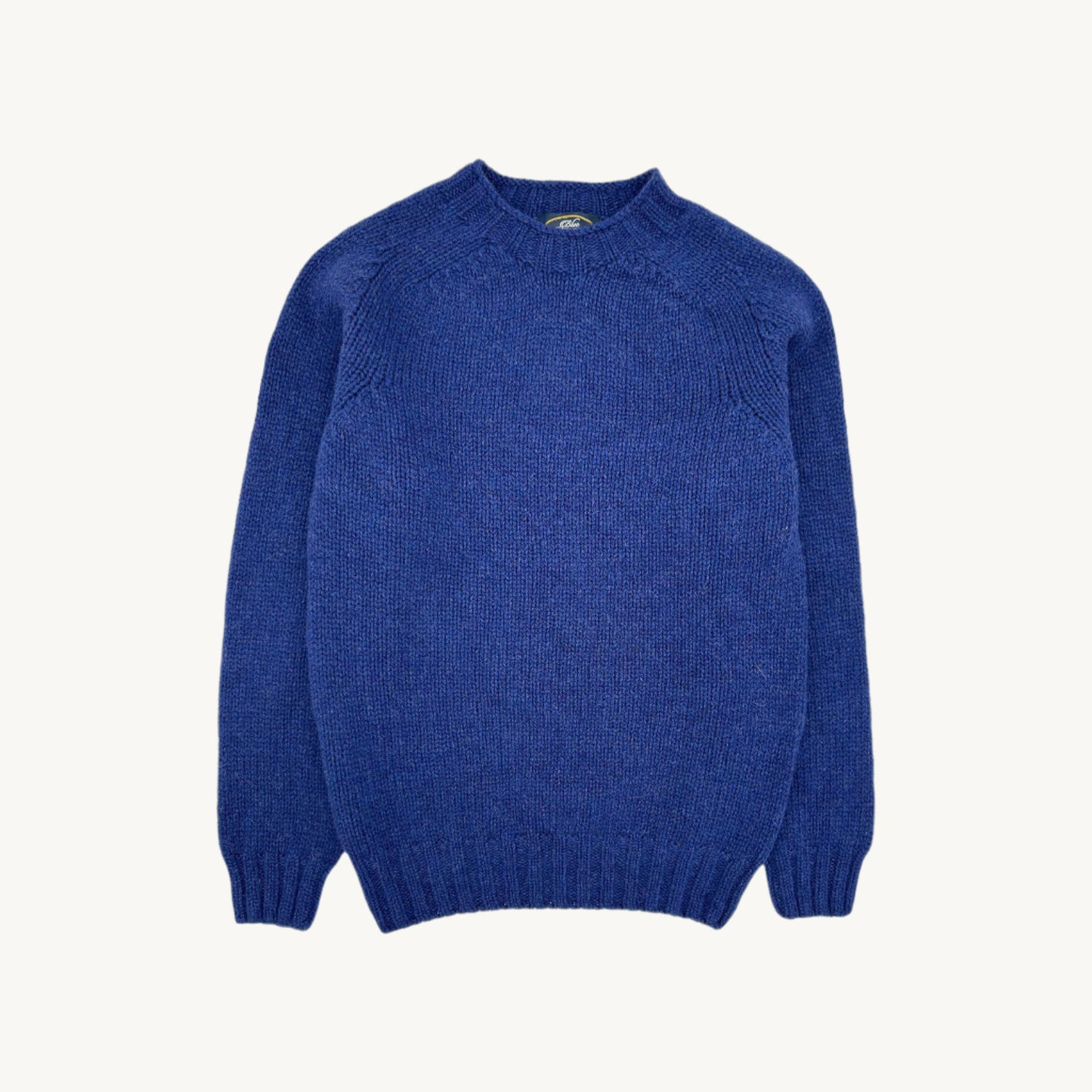 Flatbed photograph of a Bosie Knitwear Blue Mogganer Explorer Extra Chunky Seamless Supersoft Shetland Sweater in colour Oceana Blue.