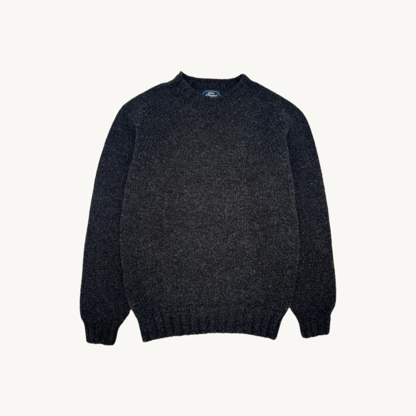 Flatbed photograph of mens 6ply chunky blue mogganer seamless saddle shoulder in colour smoulder.