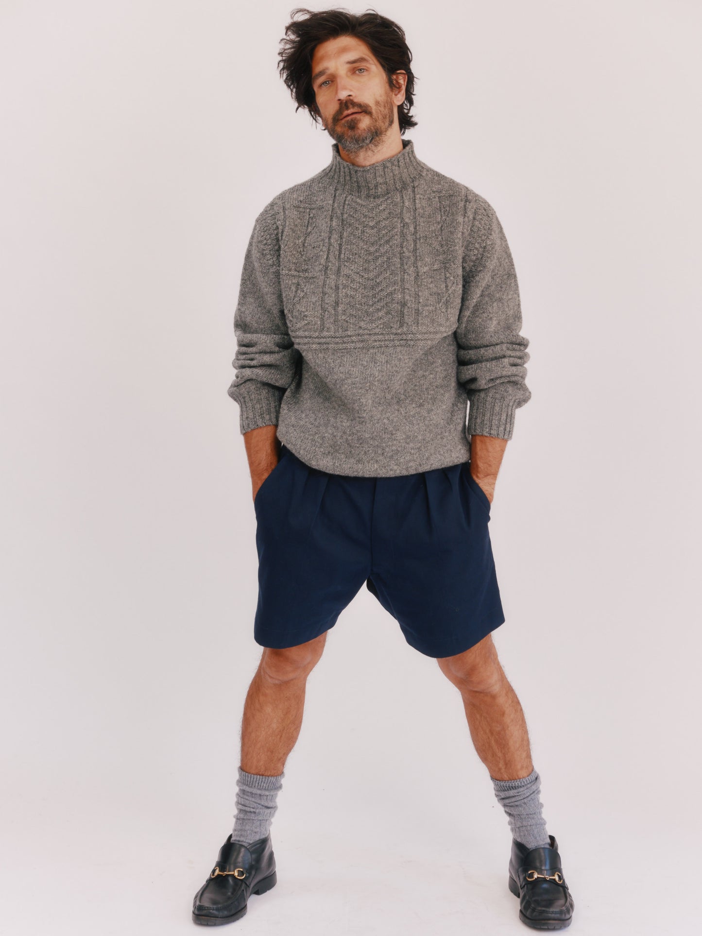 Model wearing a Bosie Knitwear Blue Mogganer Ganjey Heritage Heather Knoll Crew Neck Sweater in colour Med Grey.