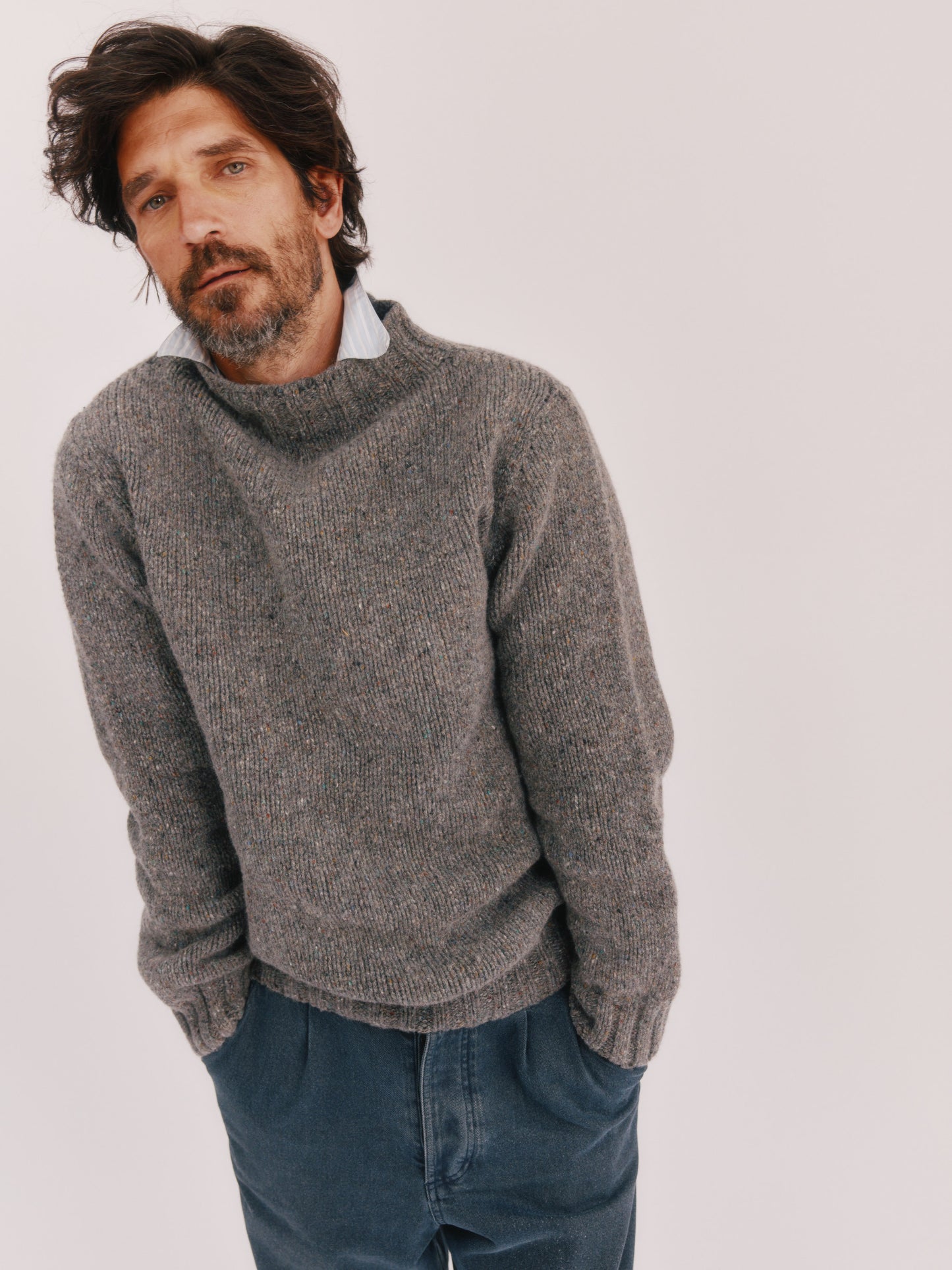Model wearing a Bosie Knitwear Blue Mogganer Glenugie Nep Funnel Neck Lighthouse Sweater in colour St Kilda Grey.
