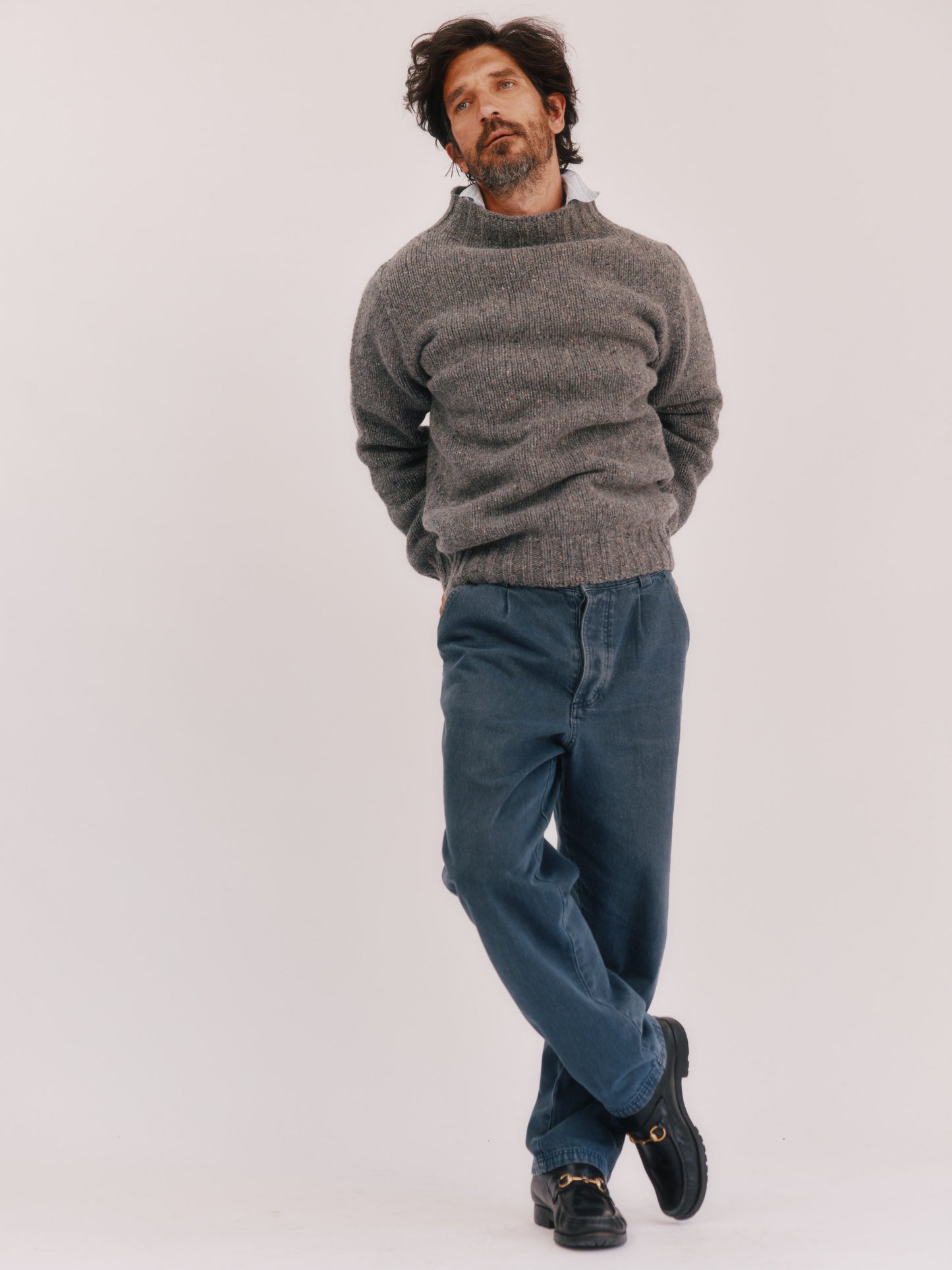 Model wearing a Bosie Knitwear Blue Mogganer Glenugie Nep Funnel Neck Lighthouse Sweater in colour St Kilda Grey.