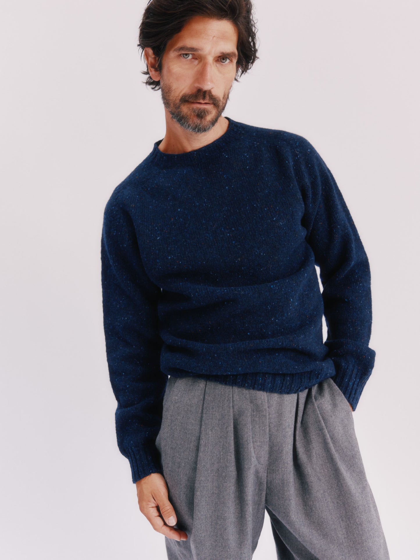 Model wearing a Bosie Knitwear Blue Mogganer Helmsman Glenugie Nep Sweater in colour Jura Navy.
