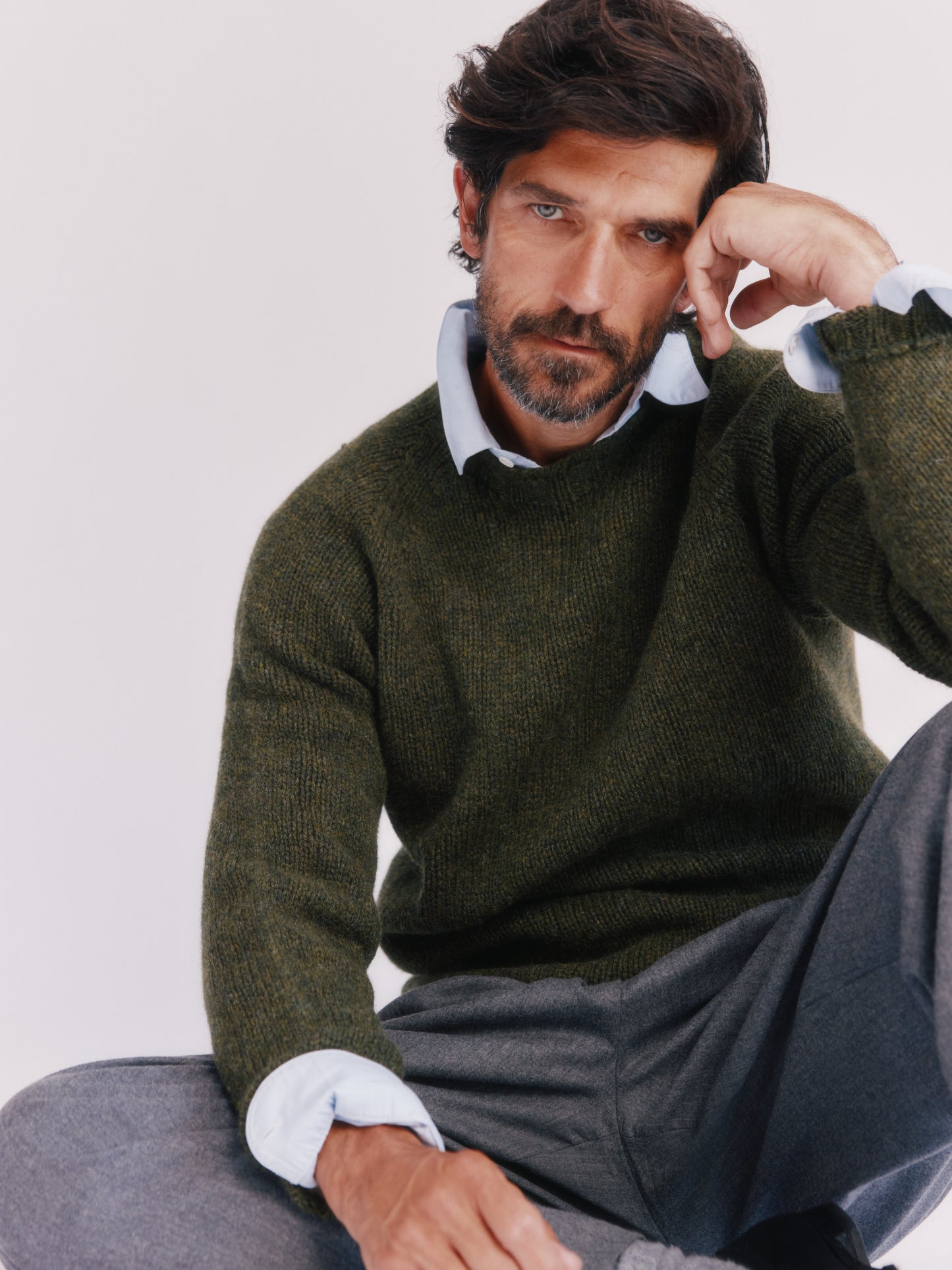 Model wearing a Bosie Knitwear Blue Mogganer North Sea Chunky Seamless Supersoft Shetland Sweater in colour Pineshadow Green.