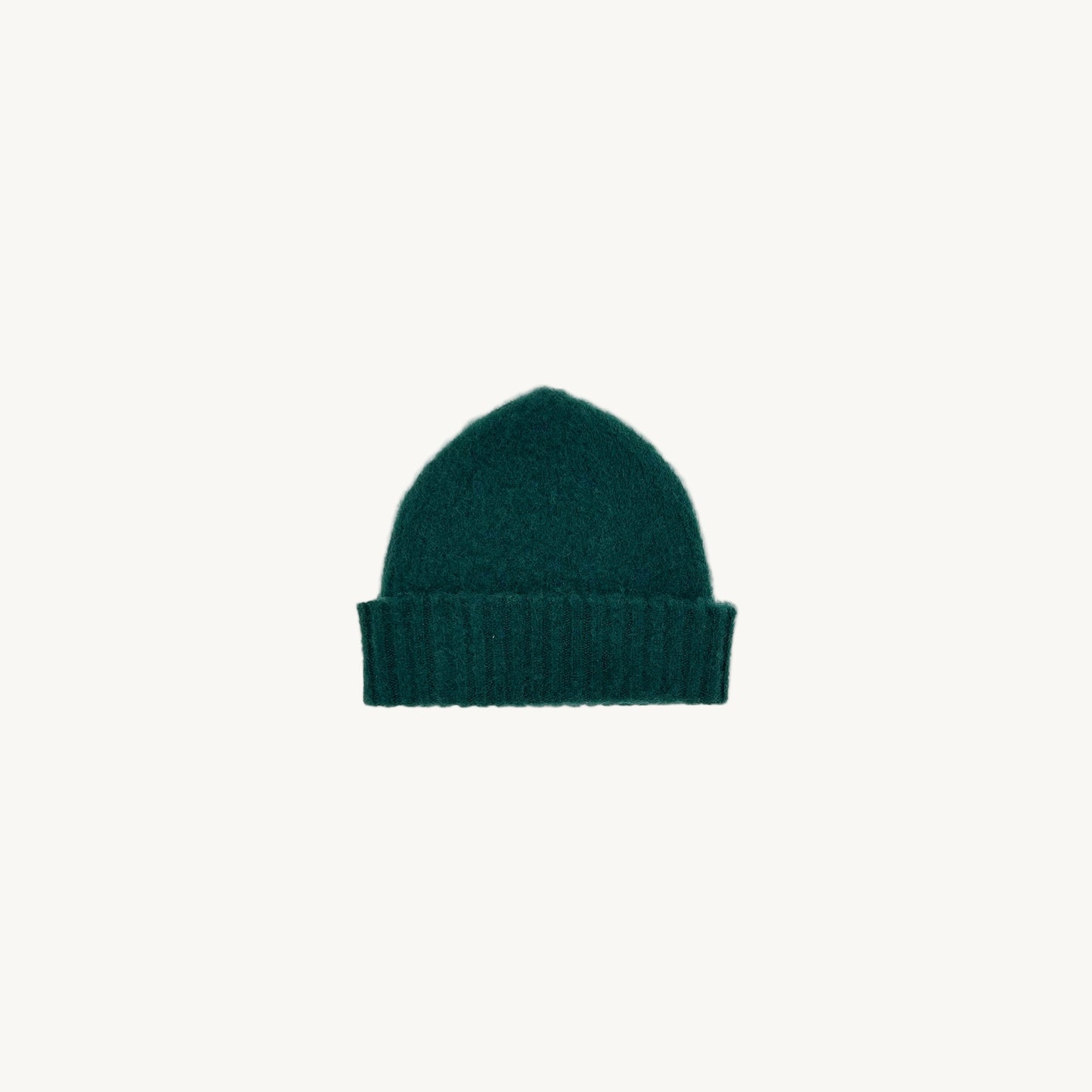 Flat bed photograph of Bosie Brushed Shetland Wool Beanie Hat in the colour Forest Green