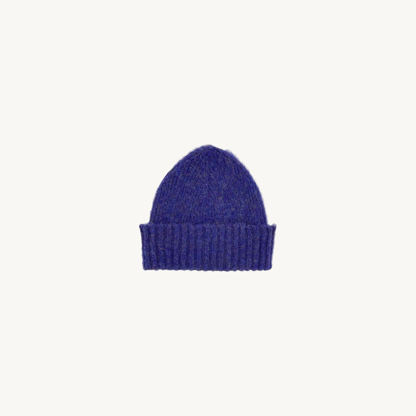 Flat bed photograph of Bosie Brushed Shetland Wool Beanie Hat in the colour Royal Violet Purple.