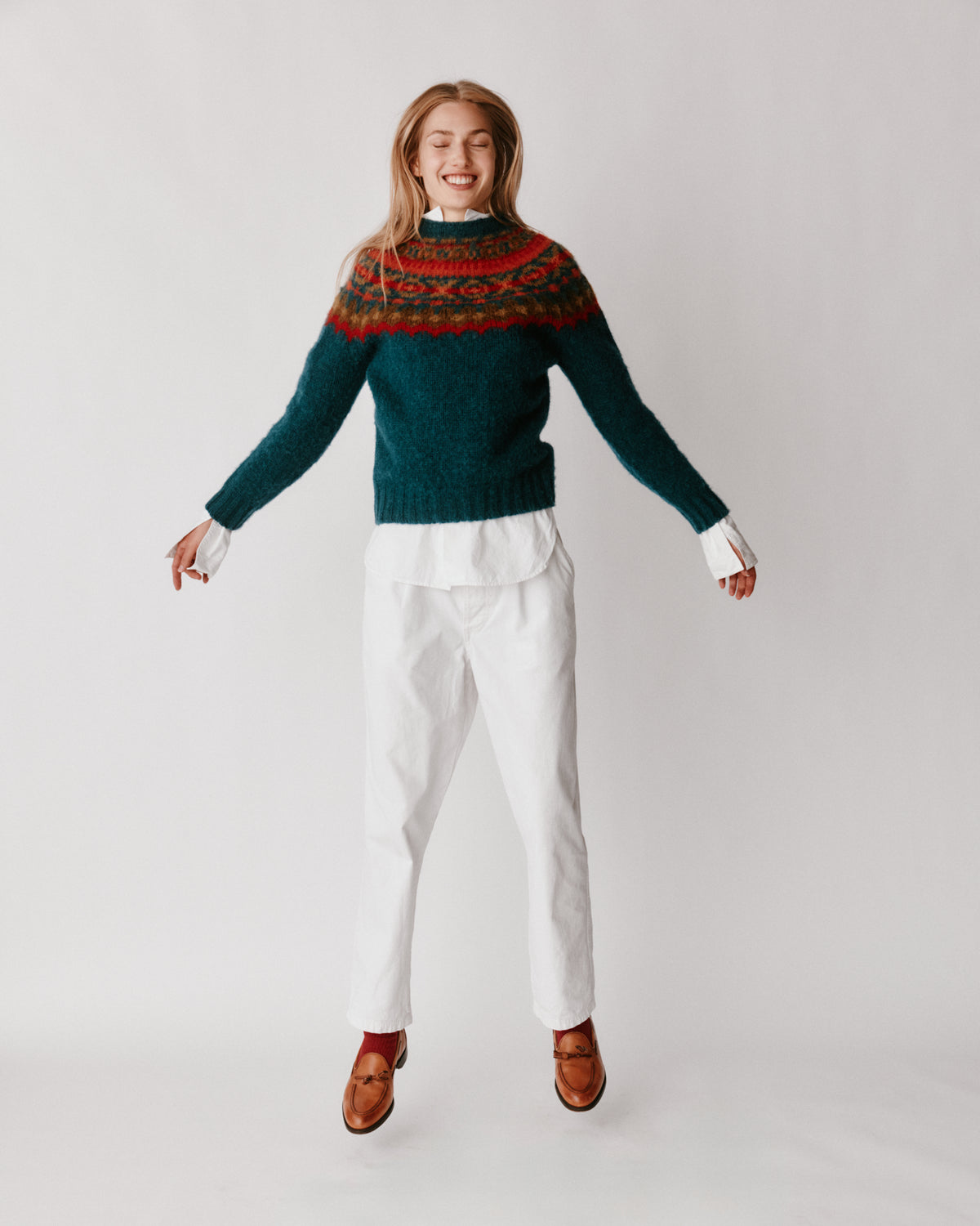 A model wearing a Bosie Braemar Yoke Brushed Fair Isle Women's Lambswool Sweater in colour Tempest.