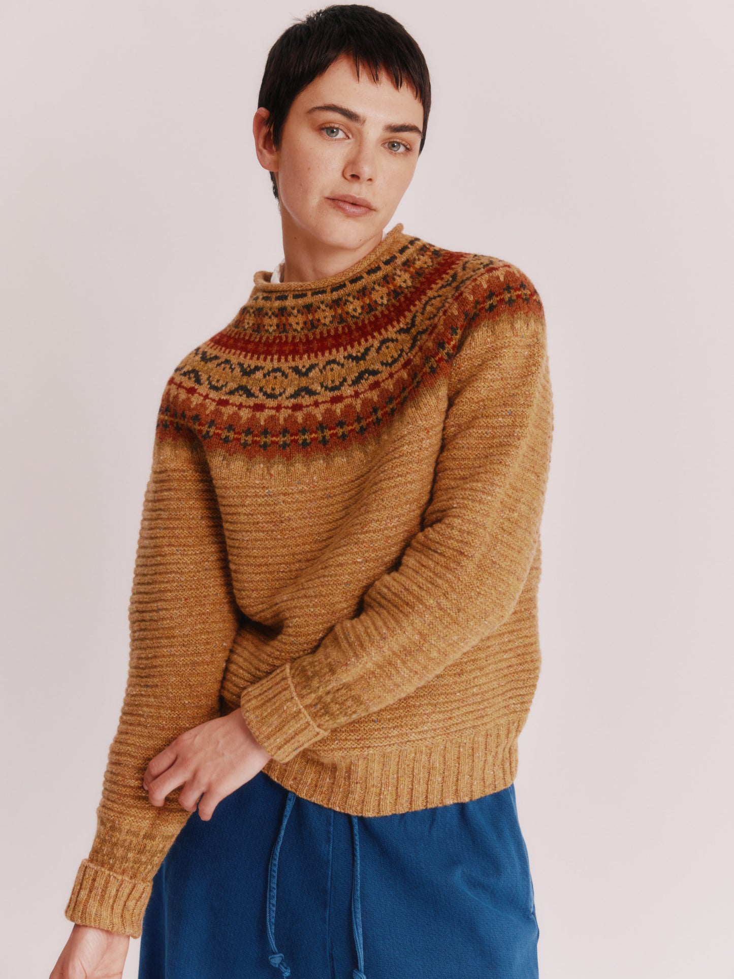 Model wearing a Bosie Knitwear Cottage Fair Isle Glenugie Nep Women's Sweater in colour Barra Gold.
