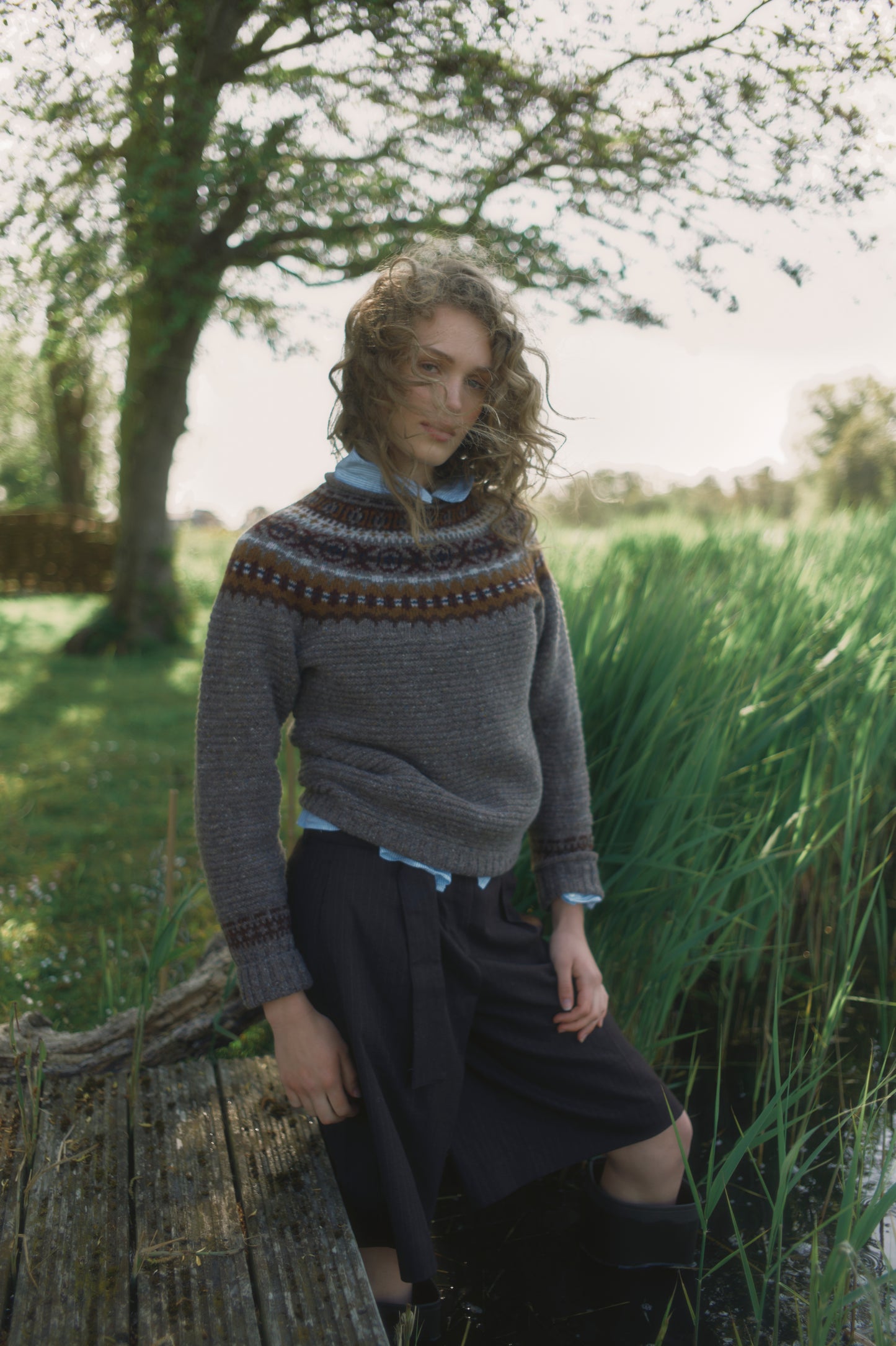 Model wearing a Bosie Knitwear Cottage Fair Isle Glenugie Nep Women's Sweater in colour Torridon Grey.