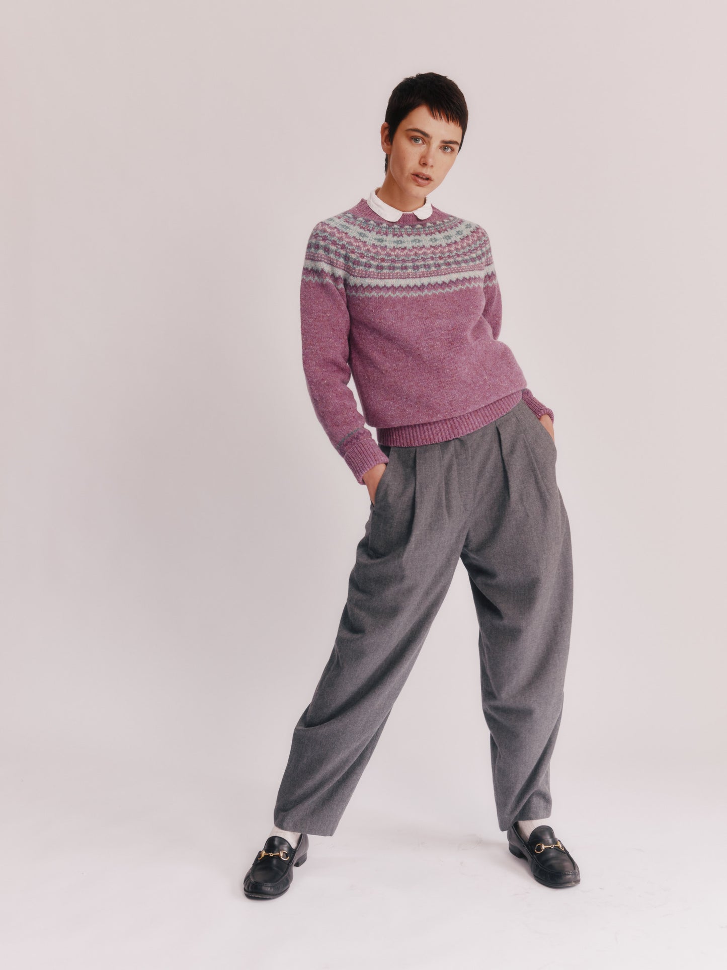 Model wearing a Bosie Knitwear Crofter Yoke Fair Isle Glenugie Nep Women's Sweater in colour Shuna Purple.
