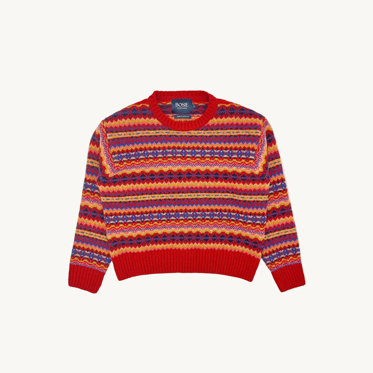 A flatbed photograph of a Bosie Cropped Allover Fair Isle Women's Sweater in colour Cardinal / French Red.
