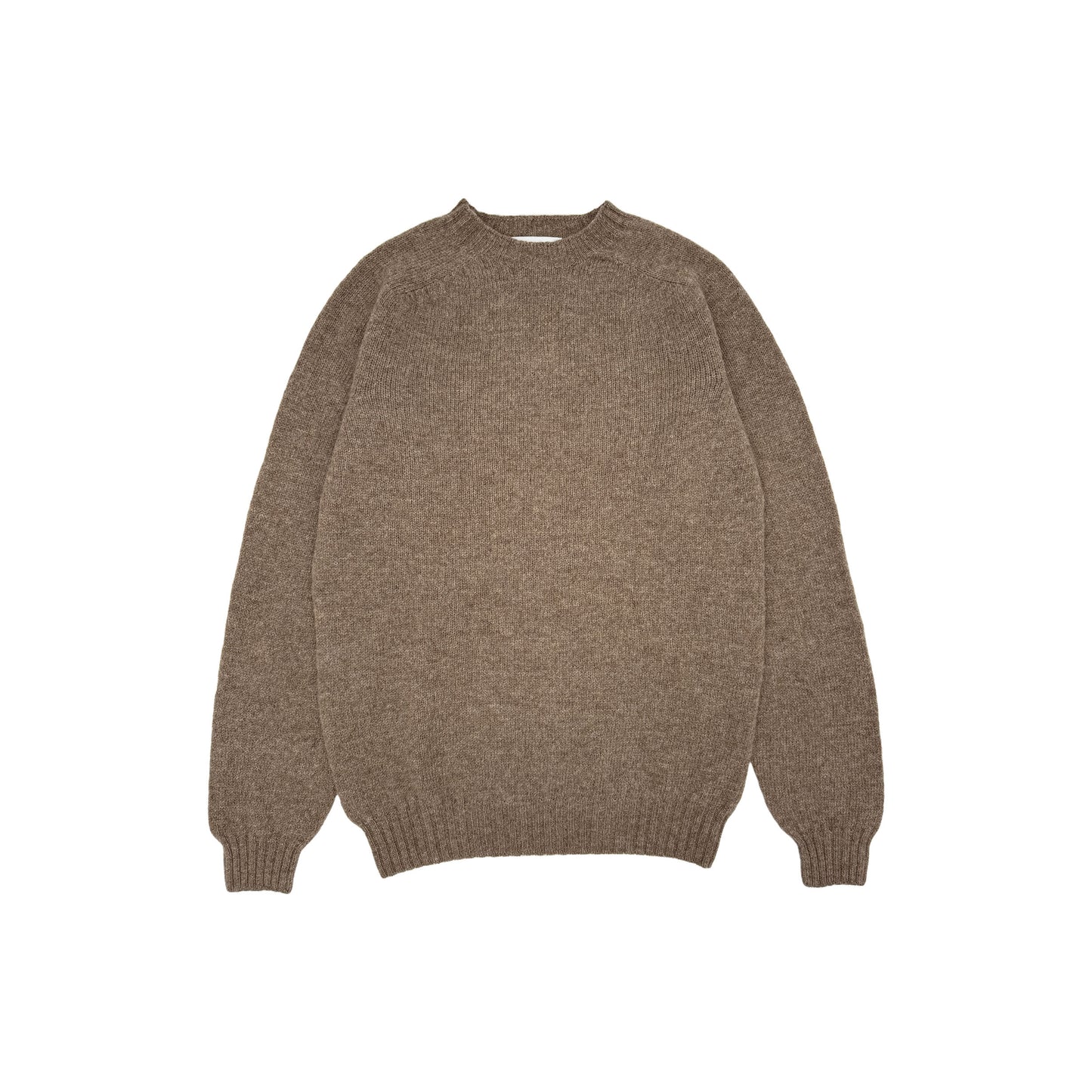 Photograph of a model wearing a harley of scotland mens seamless saddle shoulder shetland sweater in colour nutmeg brown.