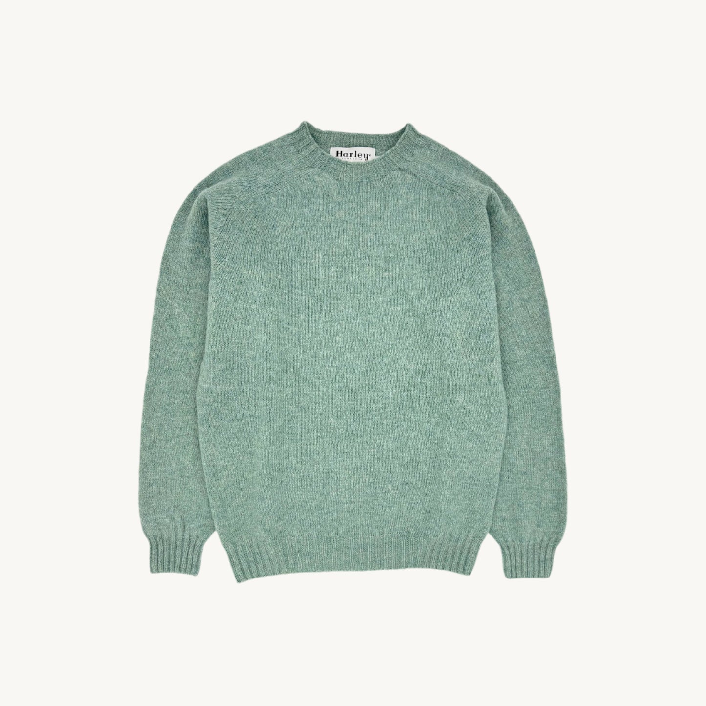 Flatbed photograph of harley of scotland seamless saddle shoulder men's shetland sweater in colour fauna green.