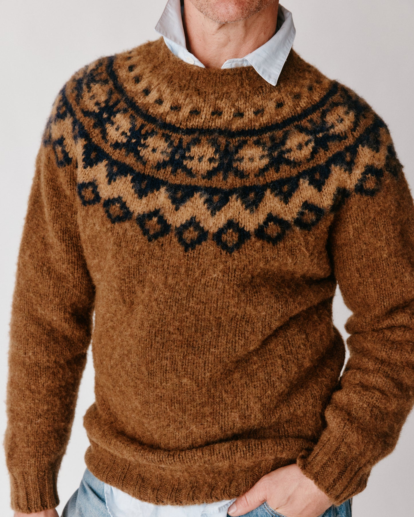A model wearing a Bosie Highland Brushed Fairisle Yoke Lambswool Sweater in colour Moorland / Dark Olive.