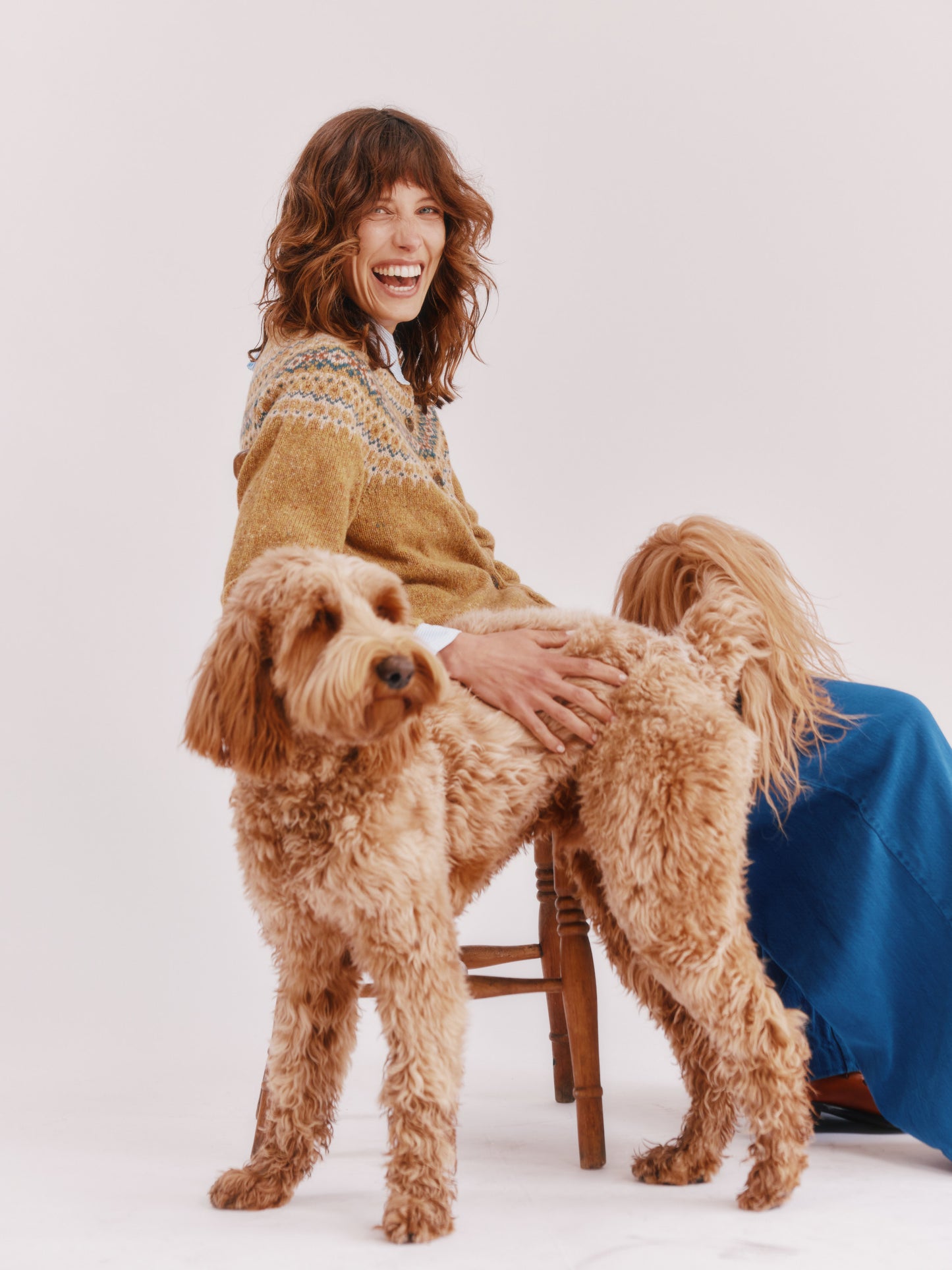 Model wearing a Bosie Knitwear Islander Yoke Fair Isle Glenugie Women's Cardigan in colour Barra Gold.