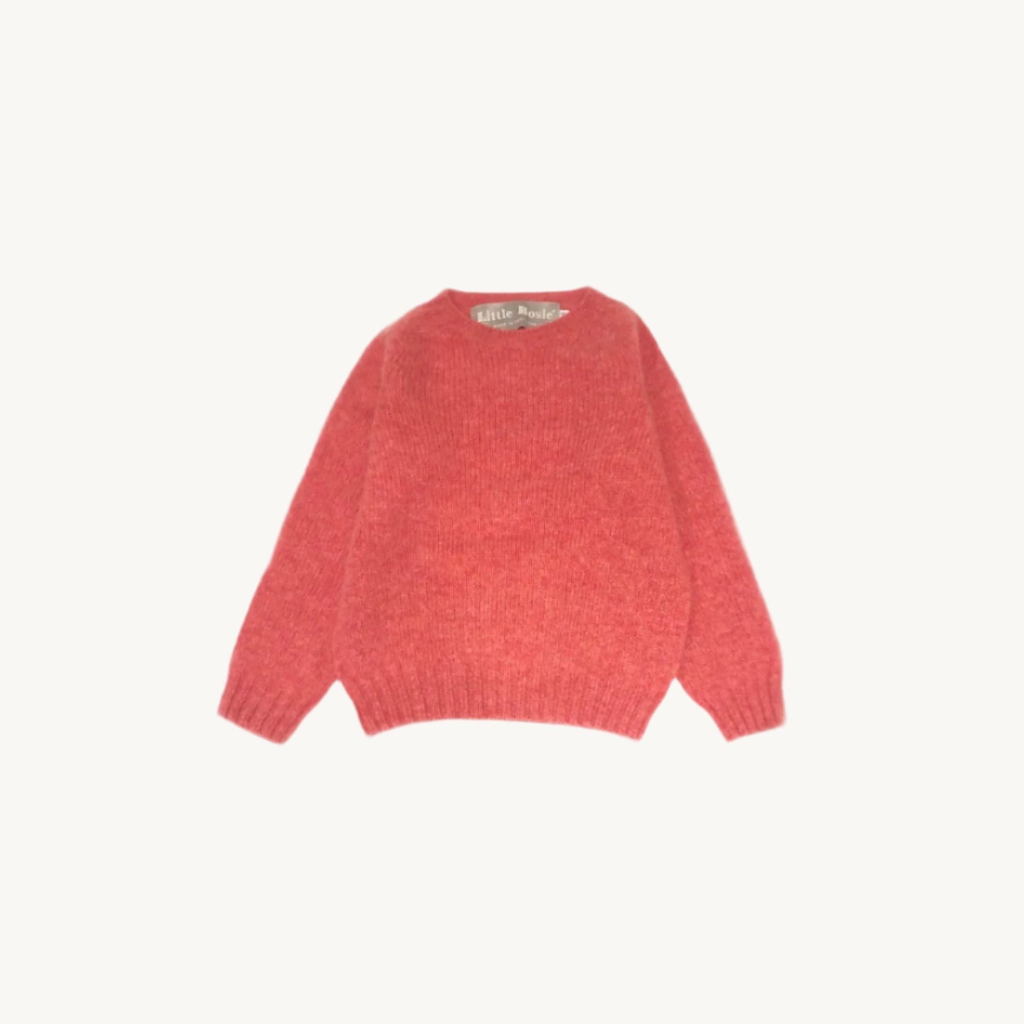 Flatbed photograph of a Bosie Little Bosie Childs Island Shetland Sweater in Rosebud Pink