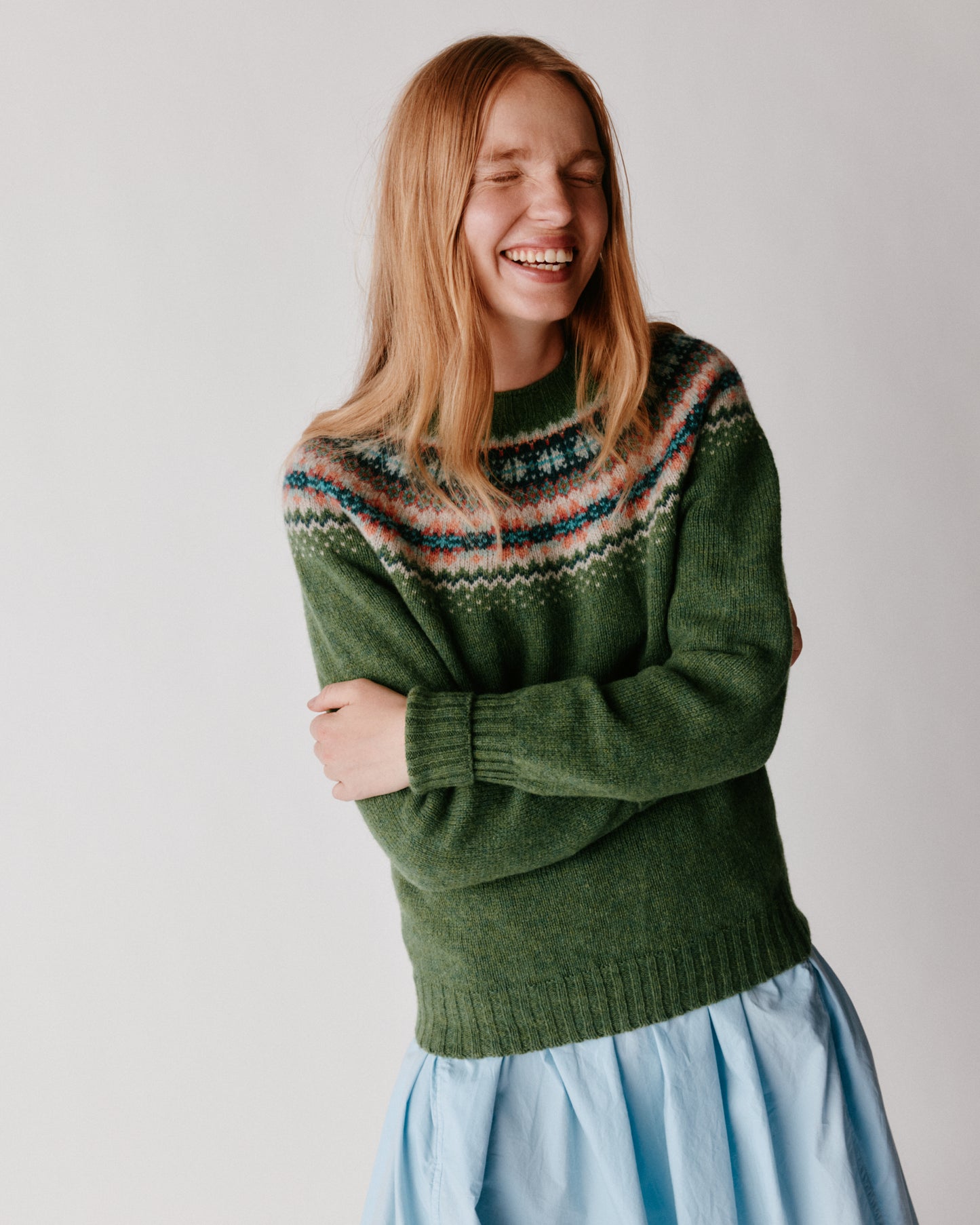 A model wearing a Bosie West Coast Yoke Fair Isle Women's Sweater in colour Baize.