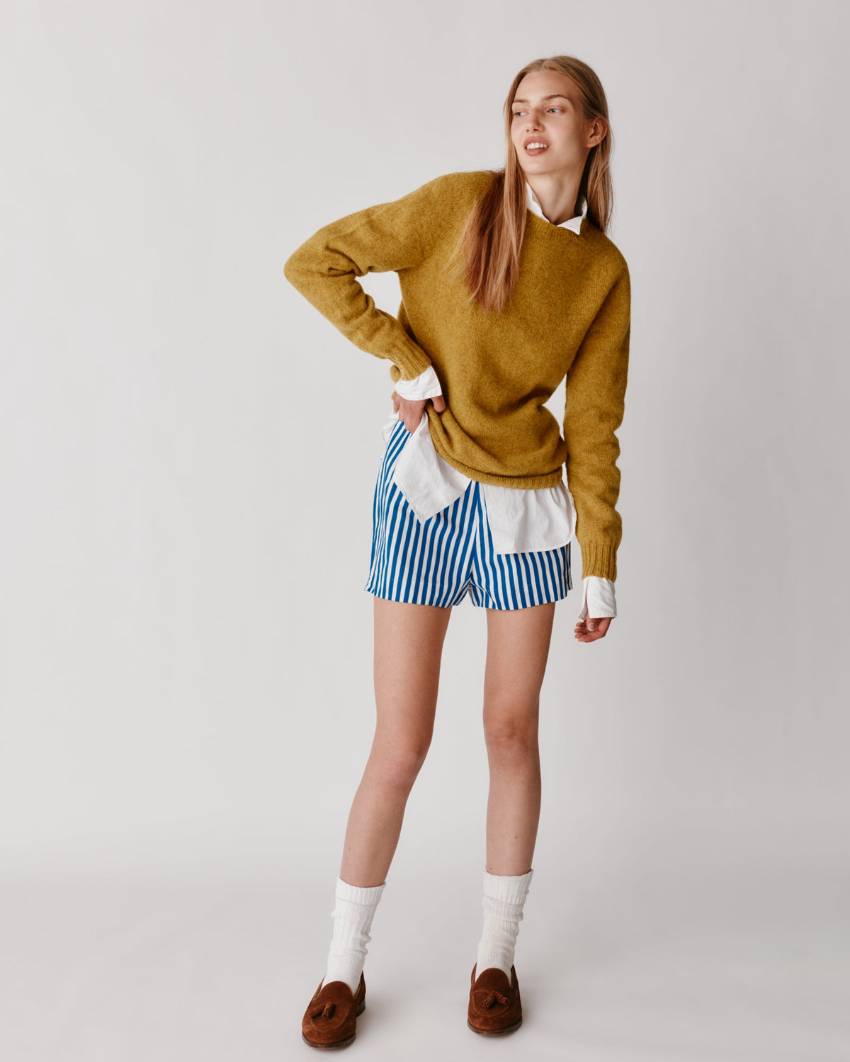 Model wearing the Bosie Women's Harley of Scotland Seamless Saddle Shoulder Shetland Sweater in Gold Dust / Cummin – seamless, seam-free pure wool, knitted in Scotland by Harley of Scotland