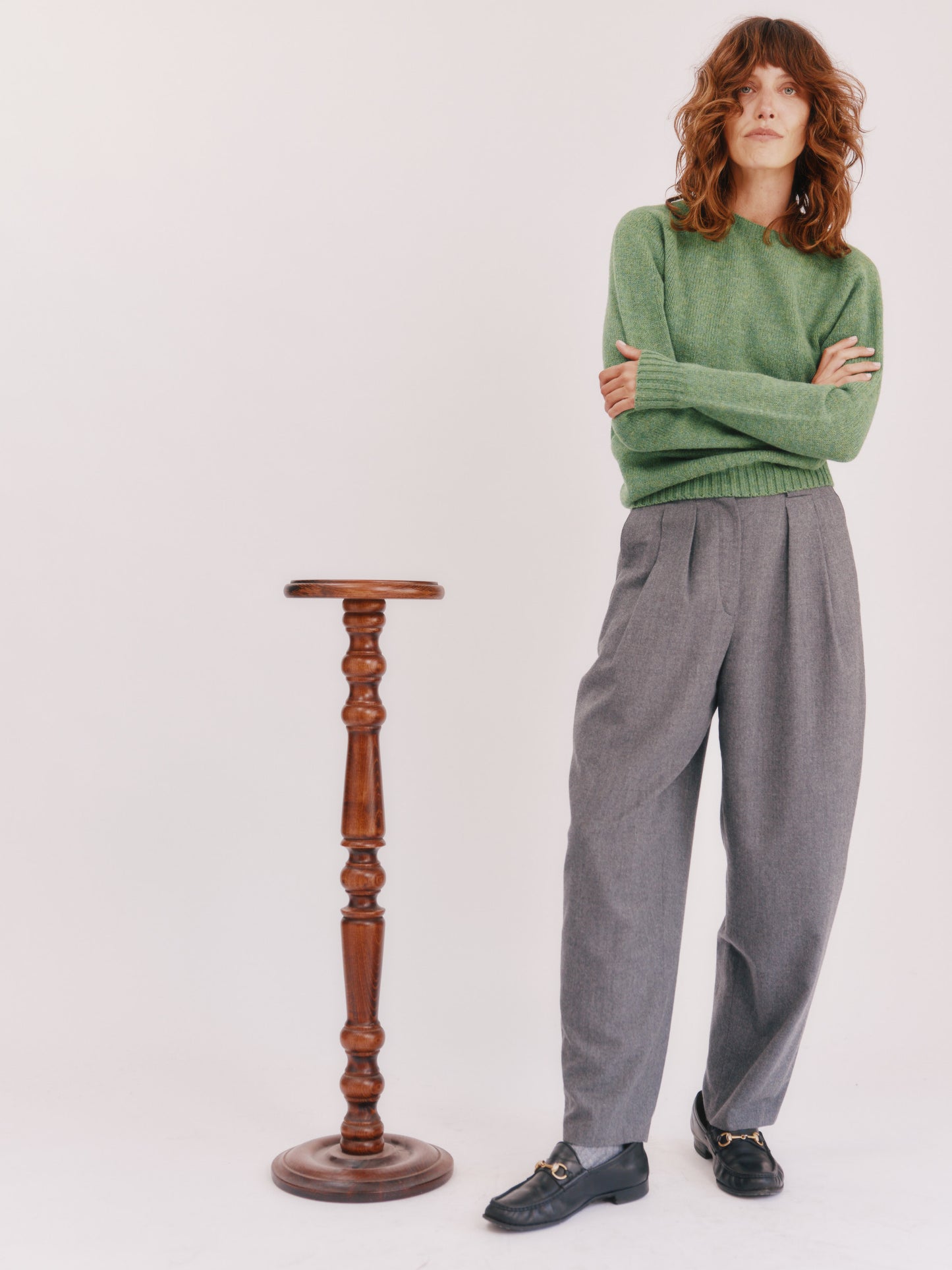 Model wearing a womens harley of scotland seamless saddle shoulder shetland sweater in colour Baize Green from Bosie Knitwear.