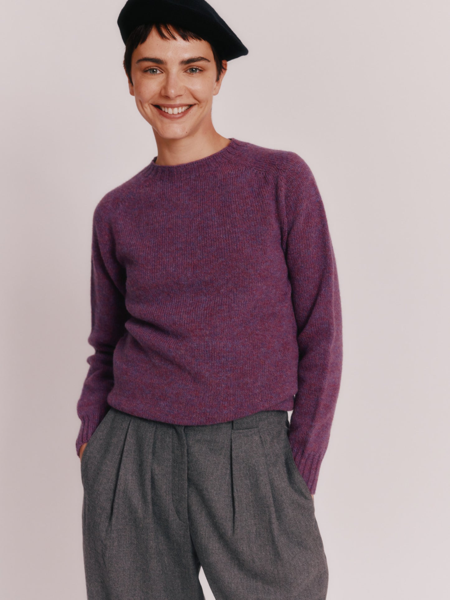 Model wearing a Womens Harley of Scotland Seamless Saddle Shoulder Shetland Sweater in colour Calluna Purple.