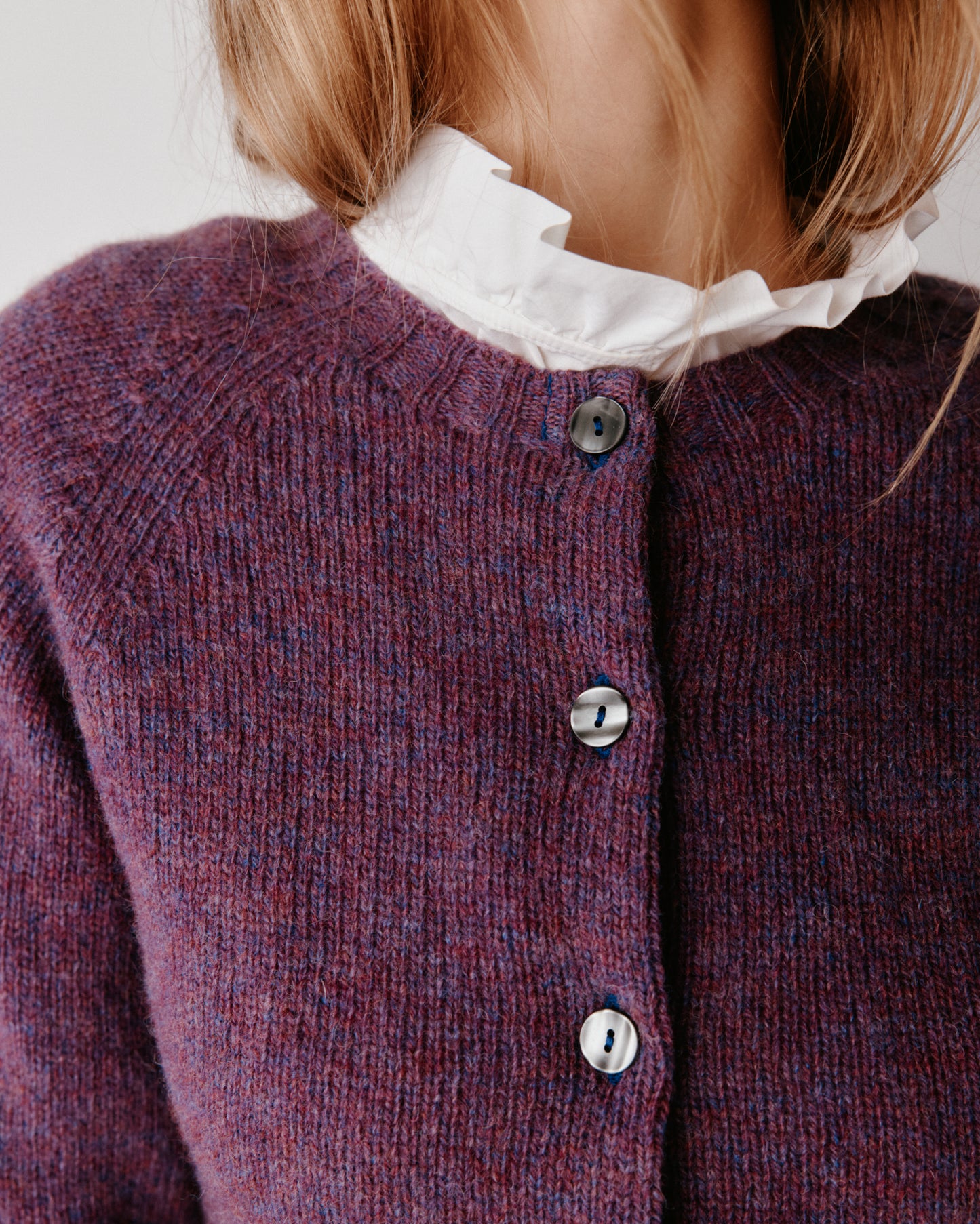 A model wearing a Bosie Womens Harley of Scotland Shetland Crew Neck Cardigan in colour Calluna.