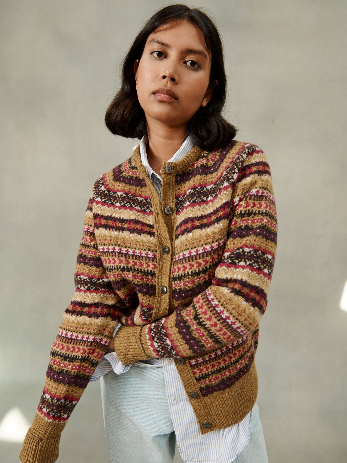 Woman wearing an asparagus brown allover Queenie fair isle cardigan in pure lambswool by Bosie Knitwear