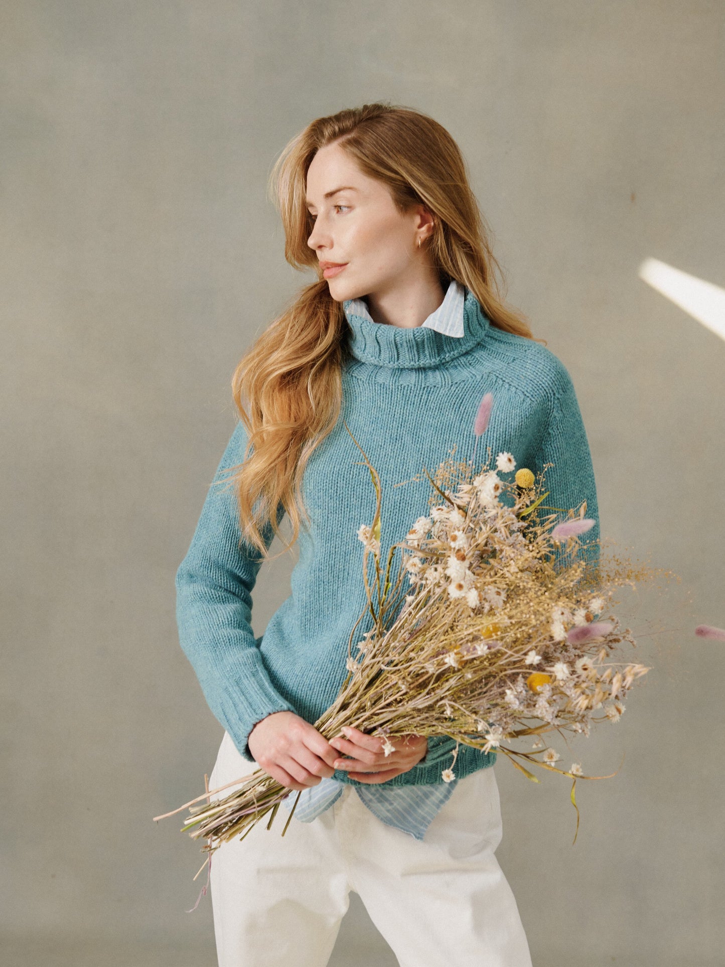 Woman wearing a women's Big Softy pribe warm blue chunky geelong polo neck sweater jumper