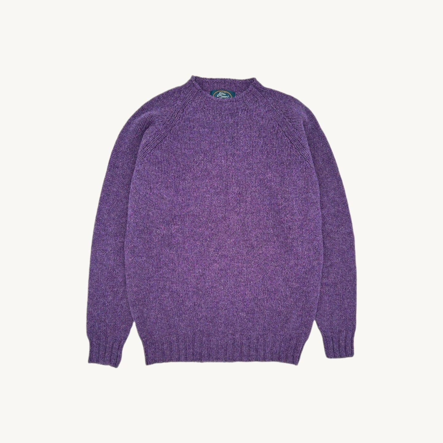 Flatbed photograph of a heather purple blue mogganer north sea shetland by bosie knitwear