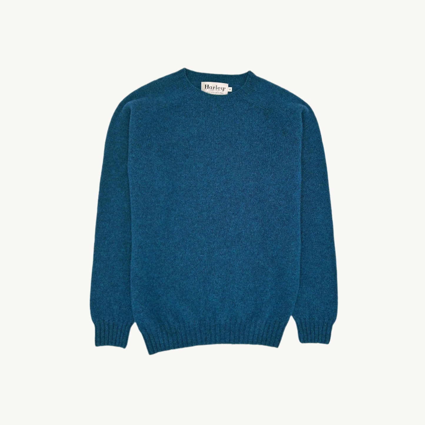 Flatbed Photograph of a Bosie Knitwear Harley of Scotland seamless saddle shoulder men's Shetland sweater jumper in Atlantic Spray Blue