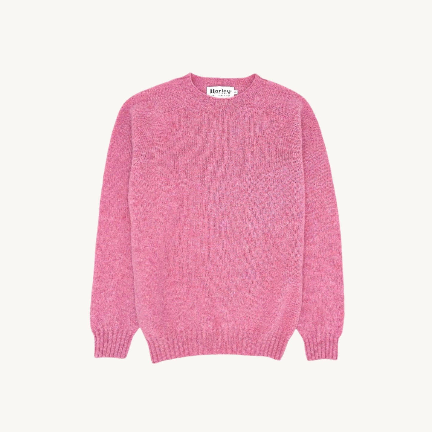 Flatbed Photograph of a Bosie Knitwear Harley of Scotland seamless saddle shoulder men's Shetland sweater jumper in Bosie Pink