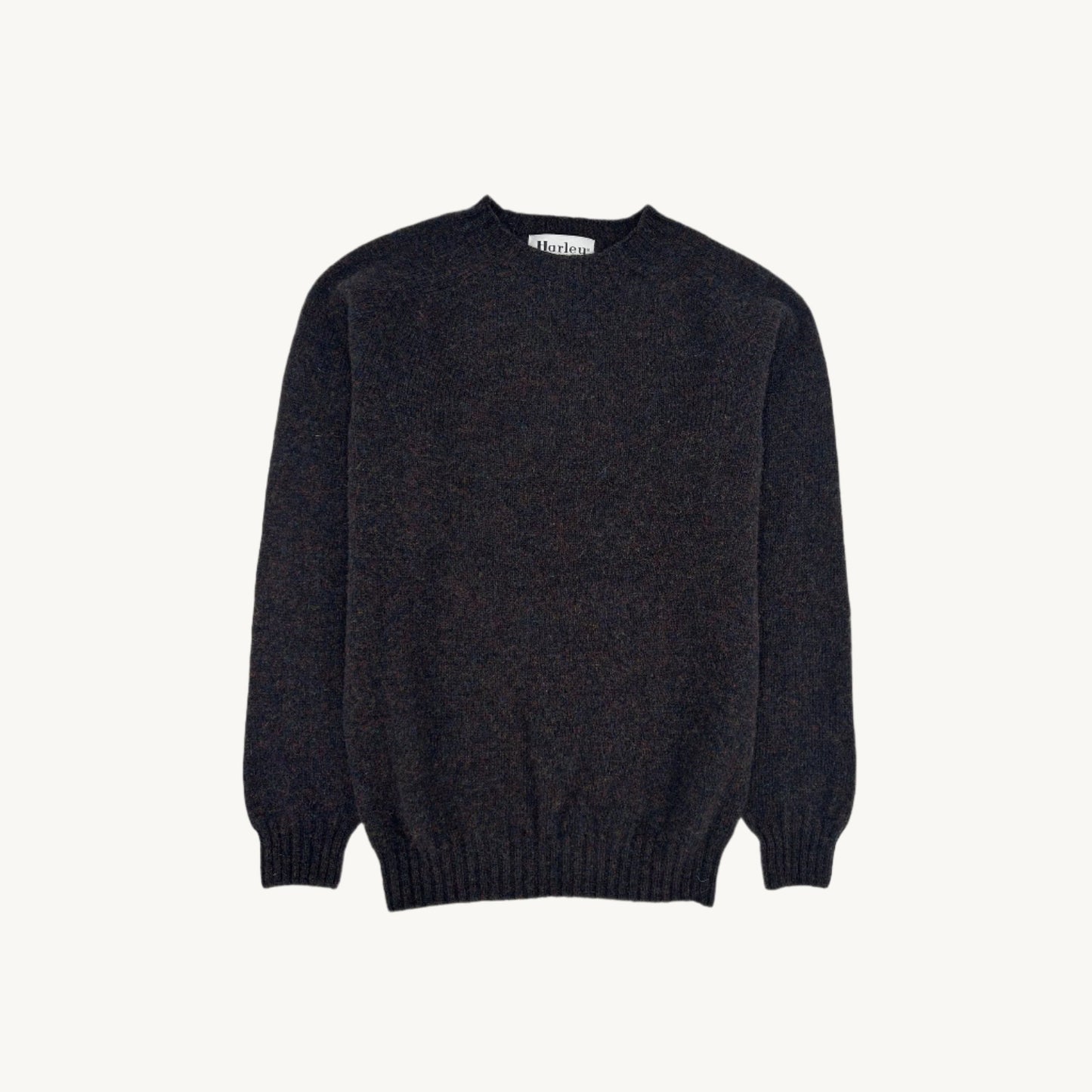 Flatbed Photograph of a Bosie Knitwear Harley of Scotland seamless saddle shoulder men's Shetland sweater jumper in Midnight Black