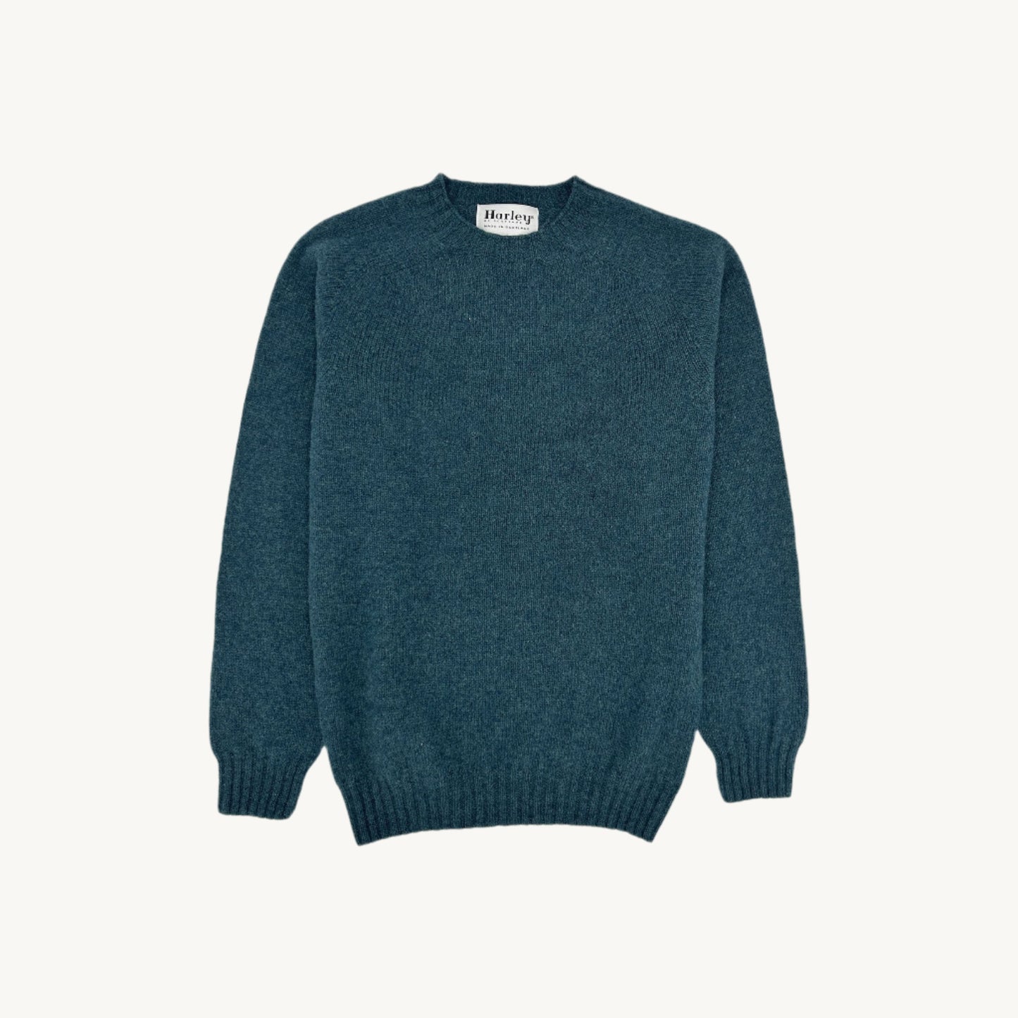 Flatbed Photograph of a Bosie Knitwear Harley of Scotland seamless saddle shoulder men's Shetland sweater jumper in Storm Dark Teal