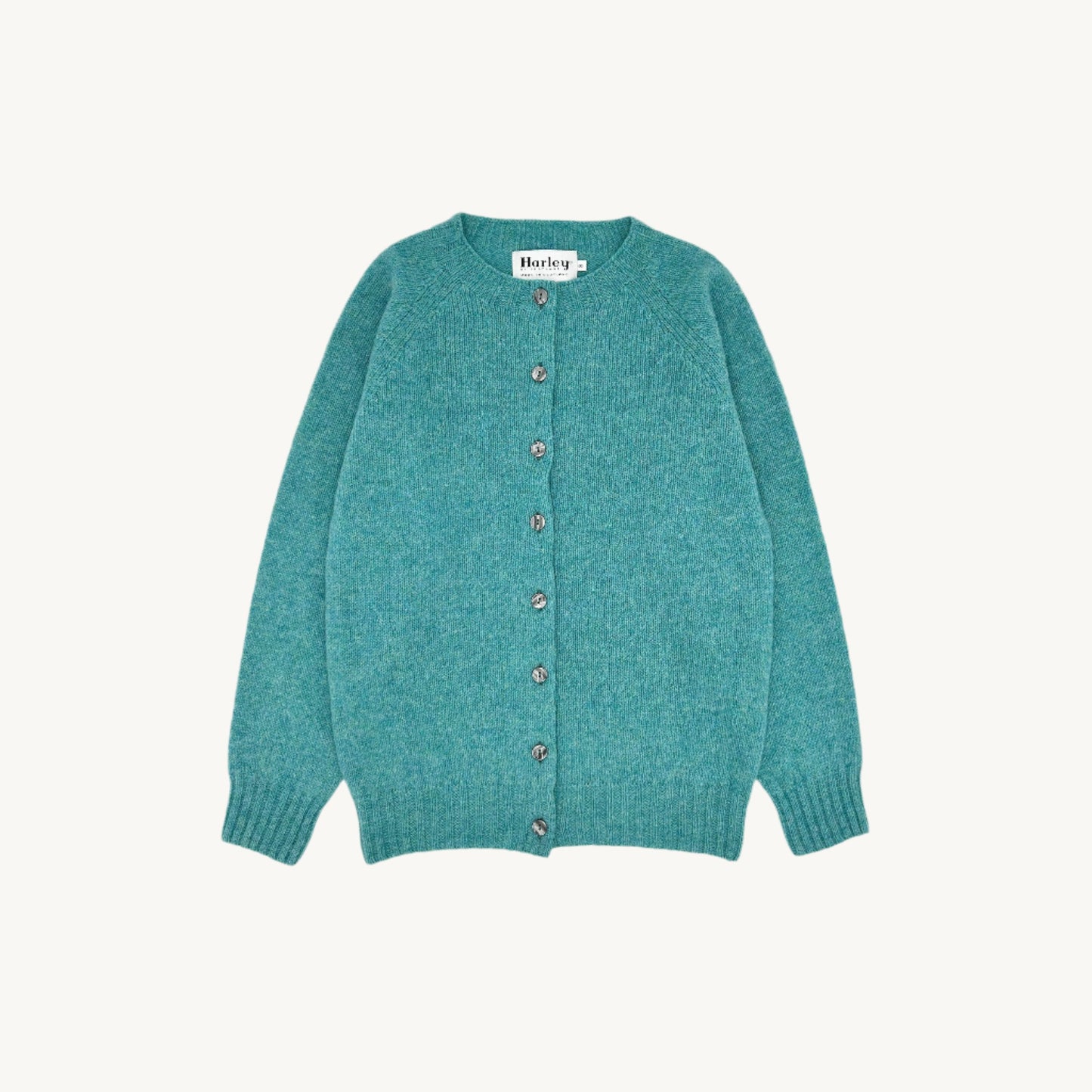 Flatbed Photograph of a Bosie Knitwear Harley of Scotland seamless saddle shoulder women's Shetland Cardigan in Marble Gemstone Blue