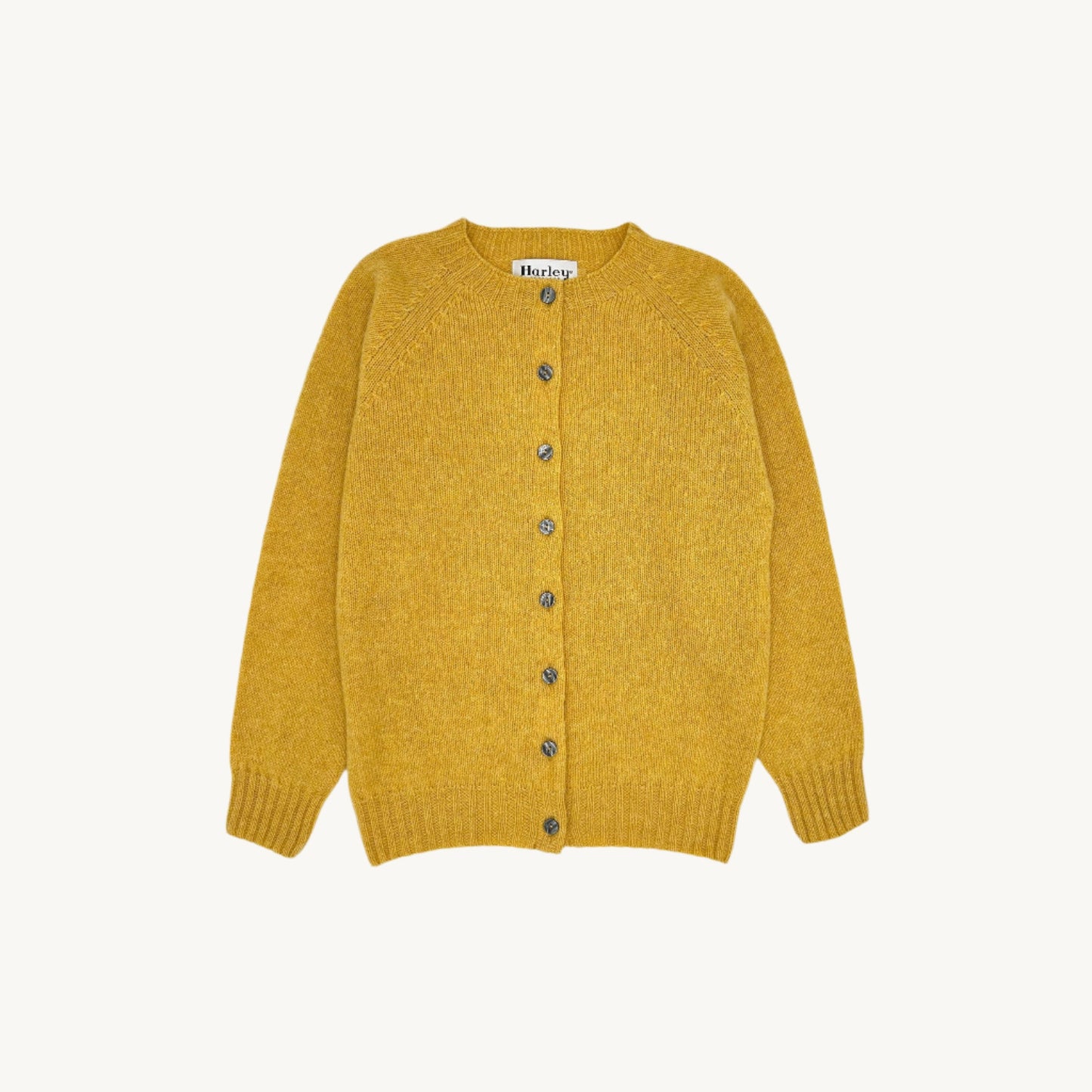Flatbed Photograph of a Bosie Knitwear Harley of Scotland seamless saddle shoulder women's Shetland Cardigan in Marzipan Yellow