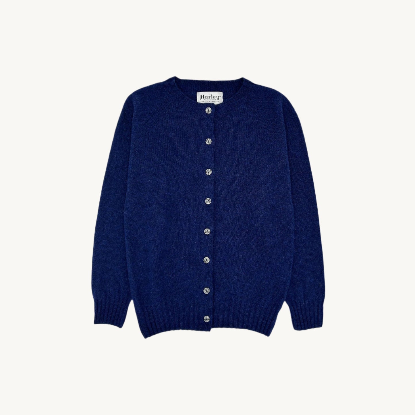 Flatbed Photograph of a Bosie Knitwear Harley of Scotland seamless saddle shoulder women's Shetland Cardigan in Starnight Blue Navy