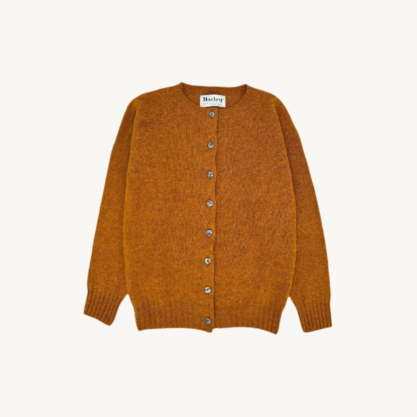 Flatbed Photograph of a Bosie Knitwear Harley of Scotland seamless saddle shoulder women's Shetland Cardigan in Vintage Orange