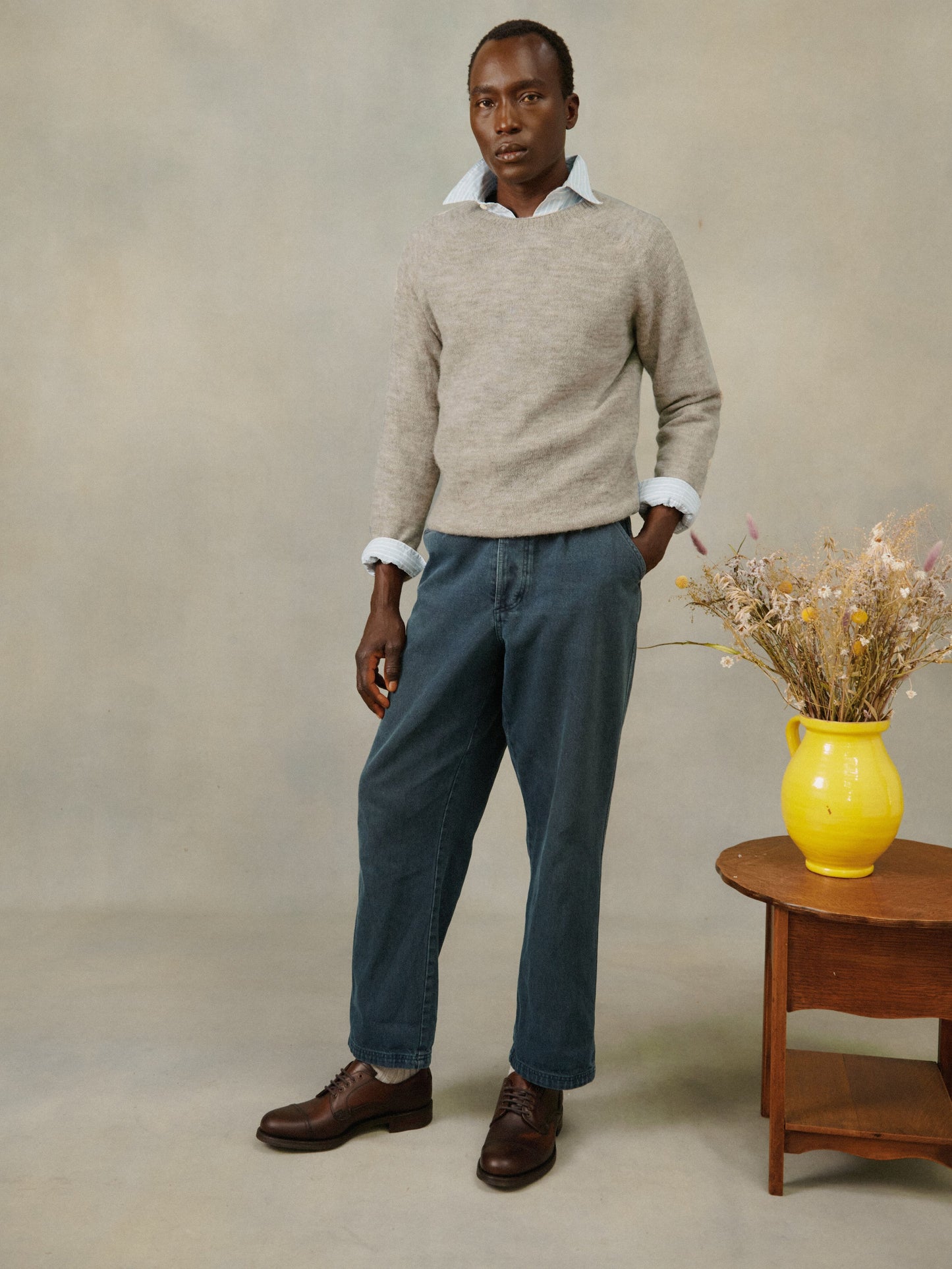 Man wearing a Bosie Knitwear Harley of Scotland undyed seamless saddle shoulder men's Everest 1 ply Voe True Shetland sweater jumper in Warm SilverSweater