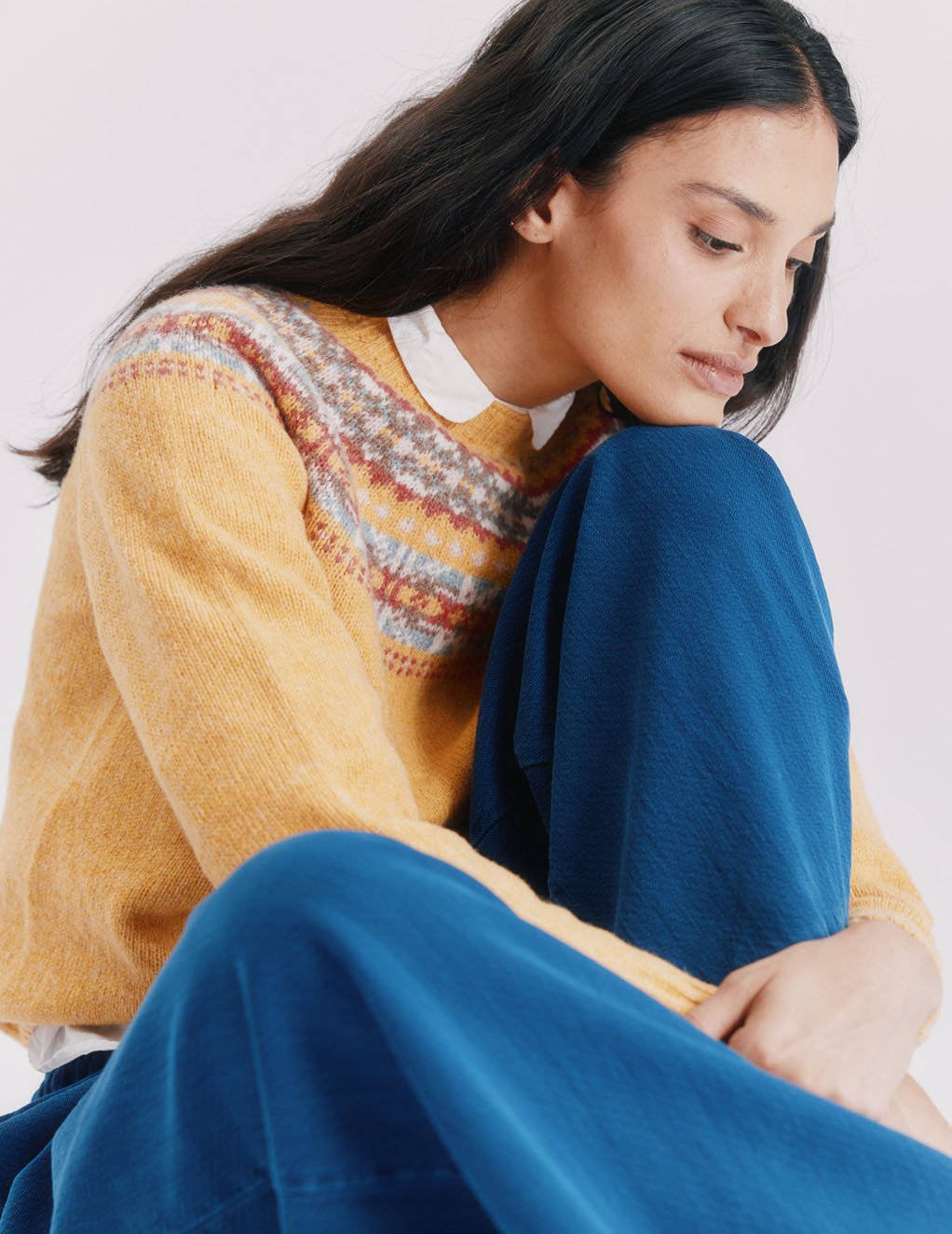 Woman wearing a marzipan yellow Bosie Skye Lambswool Fairisle Yoke Sweater