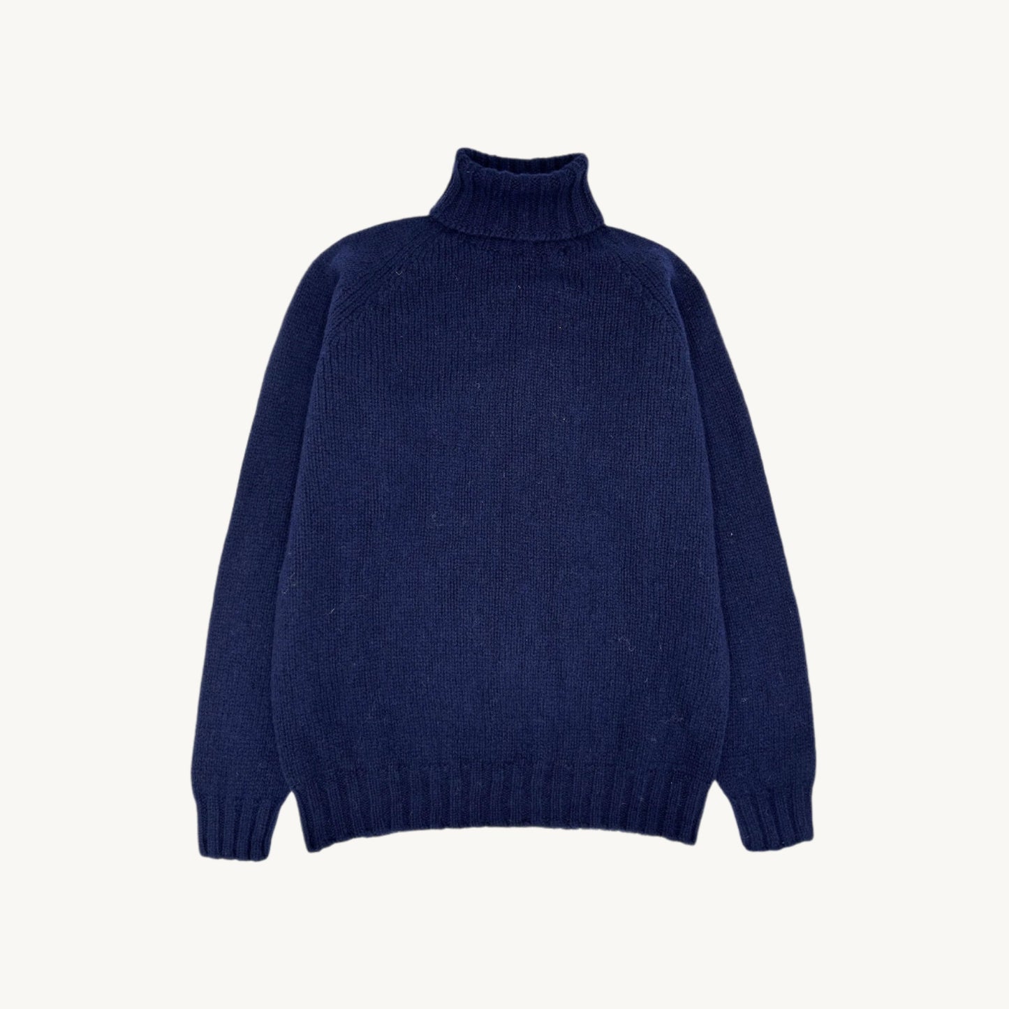 Flatbed Photograph of a Blue Mogganer Submariner Polo Neck Shetland Chunky Sweater in Navy by Bosie Knitwear