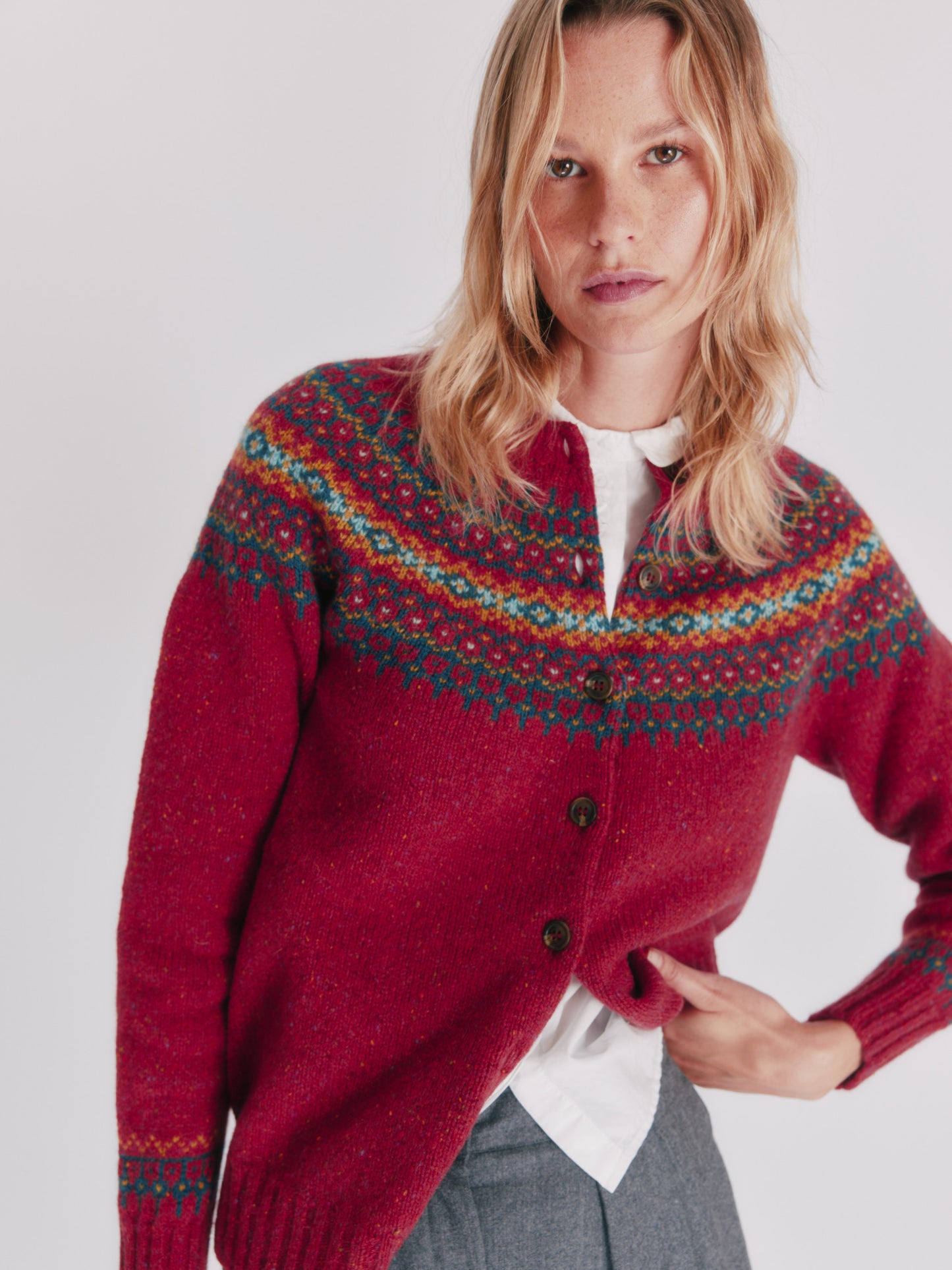 Woman wearing an oronsay red Bosie Islander Glenugie Nep Fairisle Yoke Cardigan