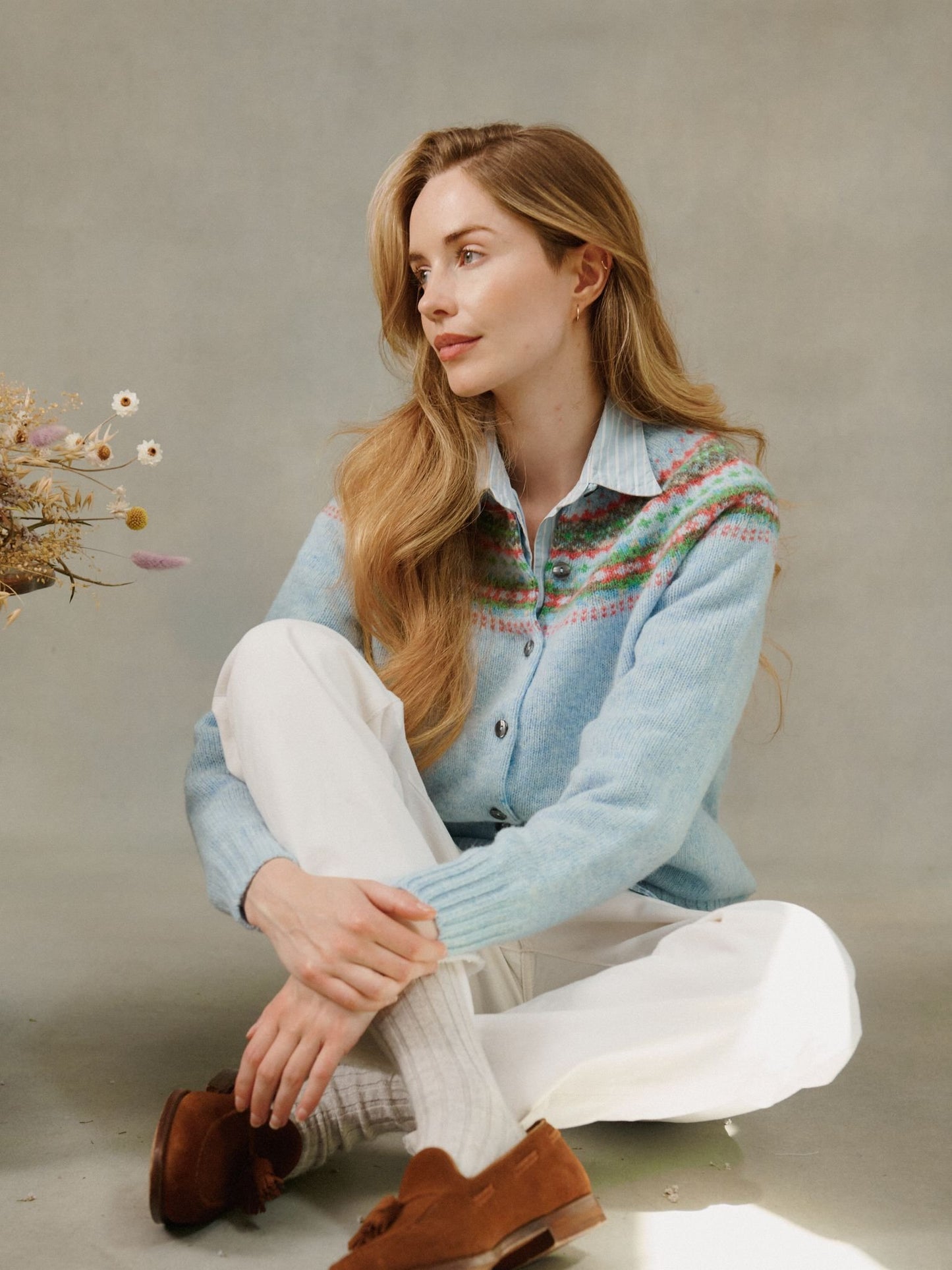 Woman wearing a powder blue Bosie Skye Lambswool Fairisle Yoke Cardigan