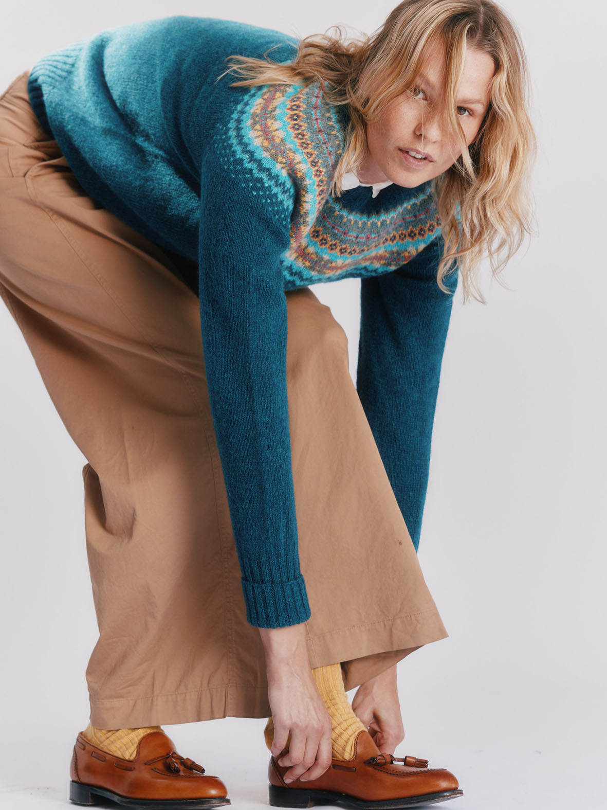 Woman wearing a storm dark teal Bosie West Coast Fairisle lambswool Sweater