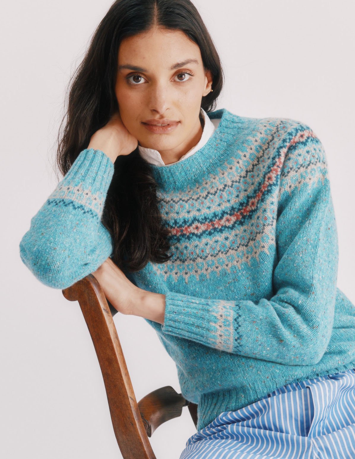 Woman wearing a Uist Aqua Blue Bosie Islander Glenugie Nep Fairisle Yoke Sweater
