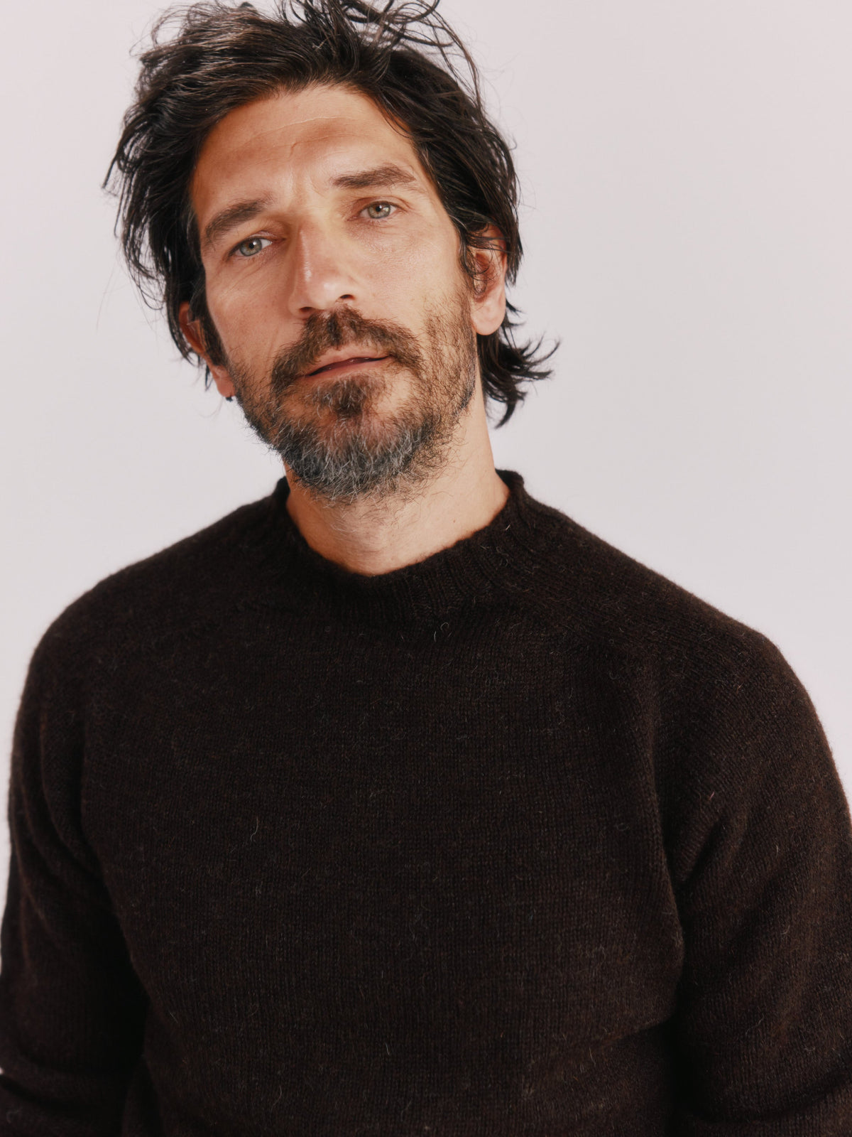 Man wearing the Bosie Sherpa Undyed Voe Shetland in Warm Black, knitted in Scotland