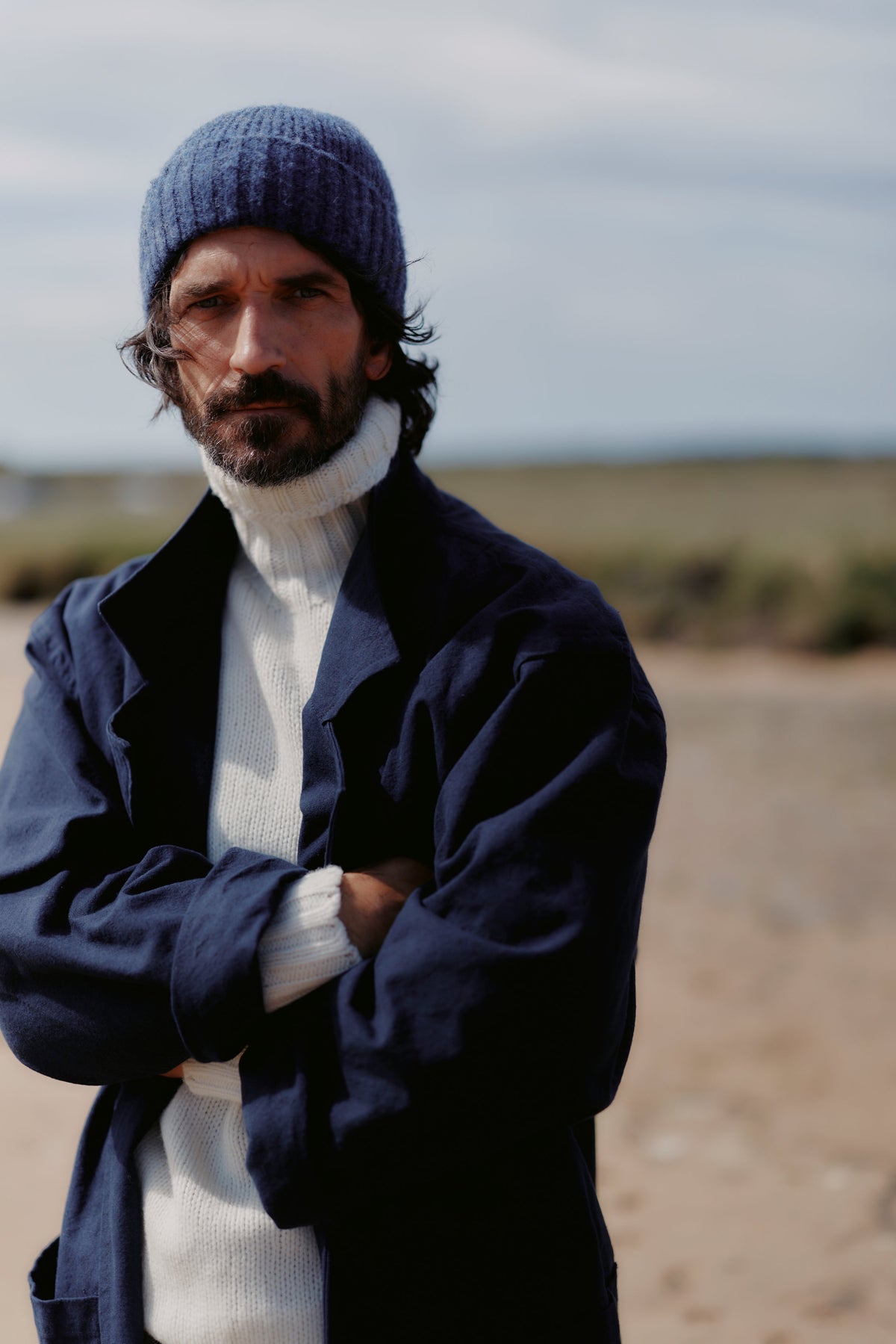 Man wearing the Bosie Blue Mogganer Submariner Chunky Shetland Polo Neck Sweater in Snow White / Winter White, knitted in Scotland