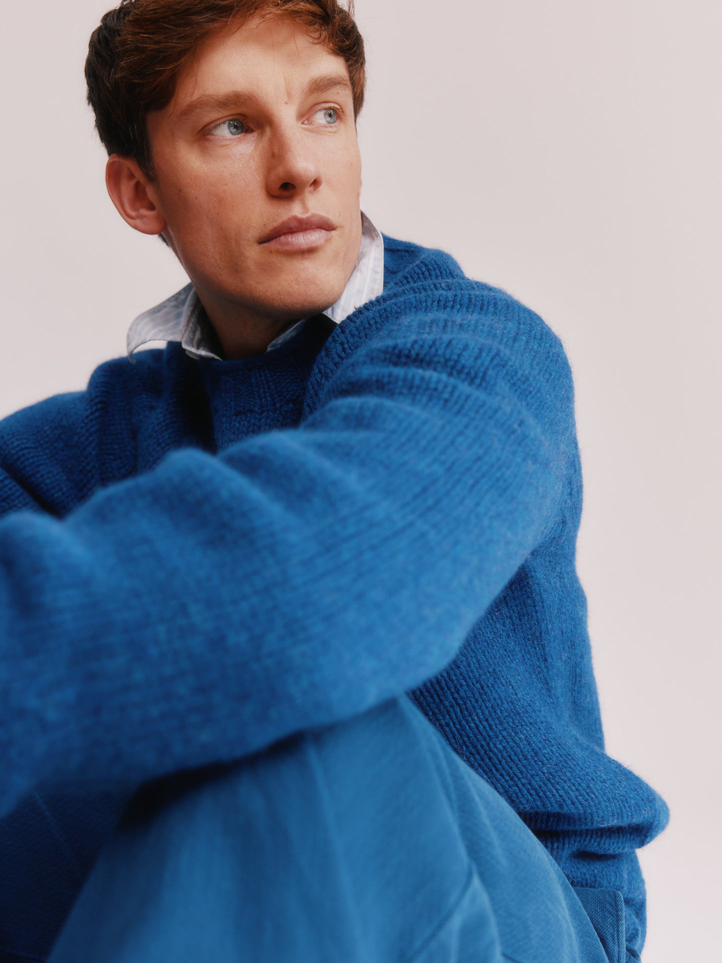 Model wearing a Bosie Knitwear Blue Mogganer Explorer Extra Chunky Seamless Supersoft Shetland Sweater in colour Oceana Blue.