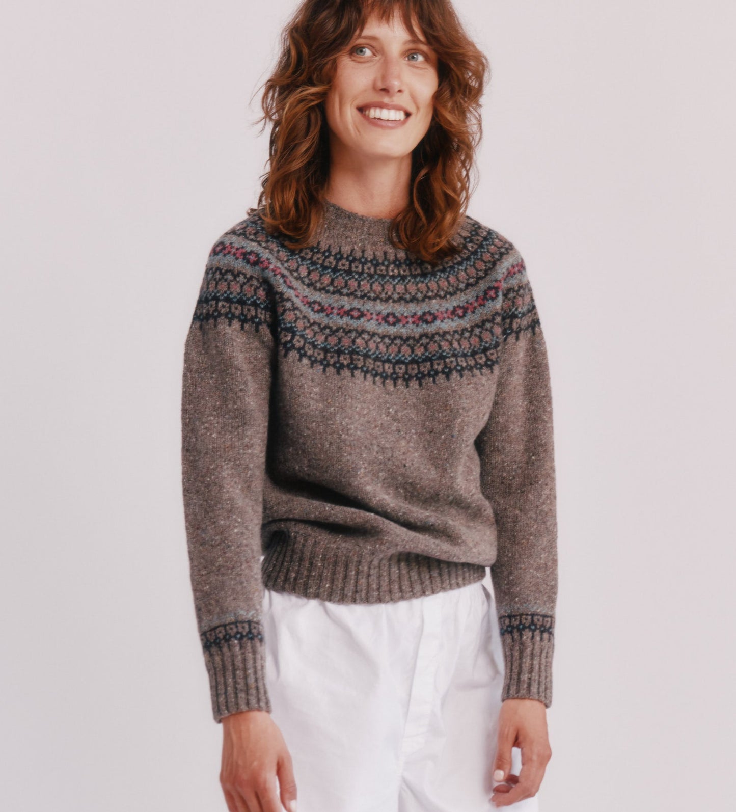 Model wearing a Bosie Knitwear Islander Yoke Fair Isle Glenugie Nep Women's Sweater  in colour Torridon Grey.