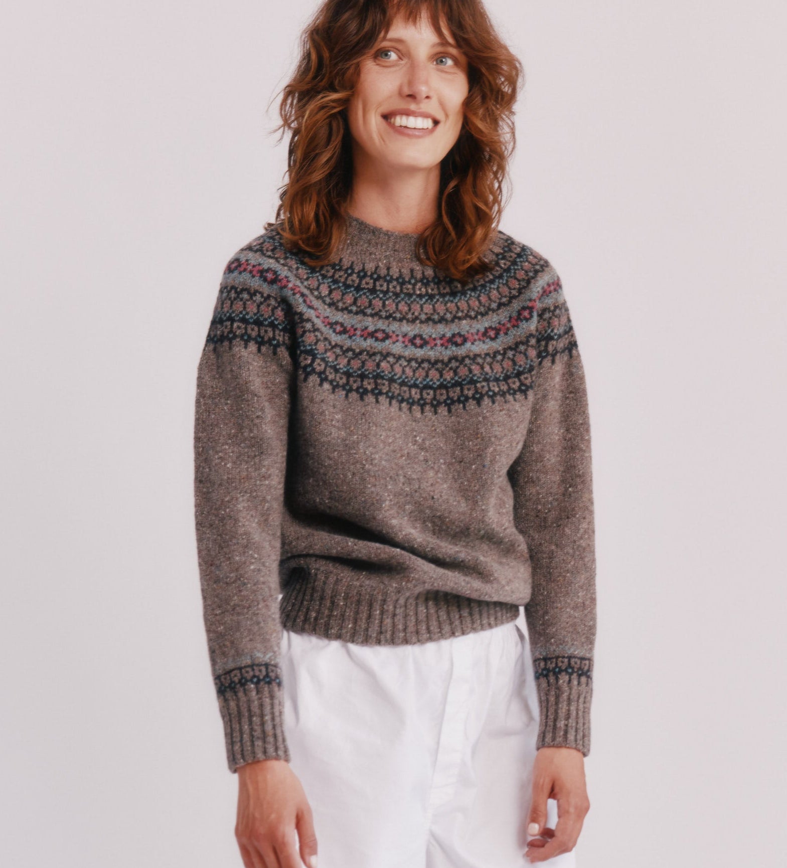 Model wearing a Bosie Knitwear Islander Yoke Fair Isle Glenugie Nep Women's Sweater  in colour Torridon Grey.