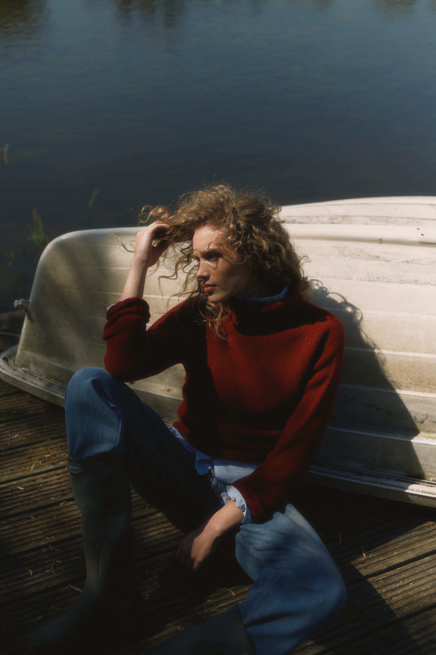 Model wearing a Big Softy Geelong Chunky Polo Neck Womens Jumper in colour Russet Red.